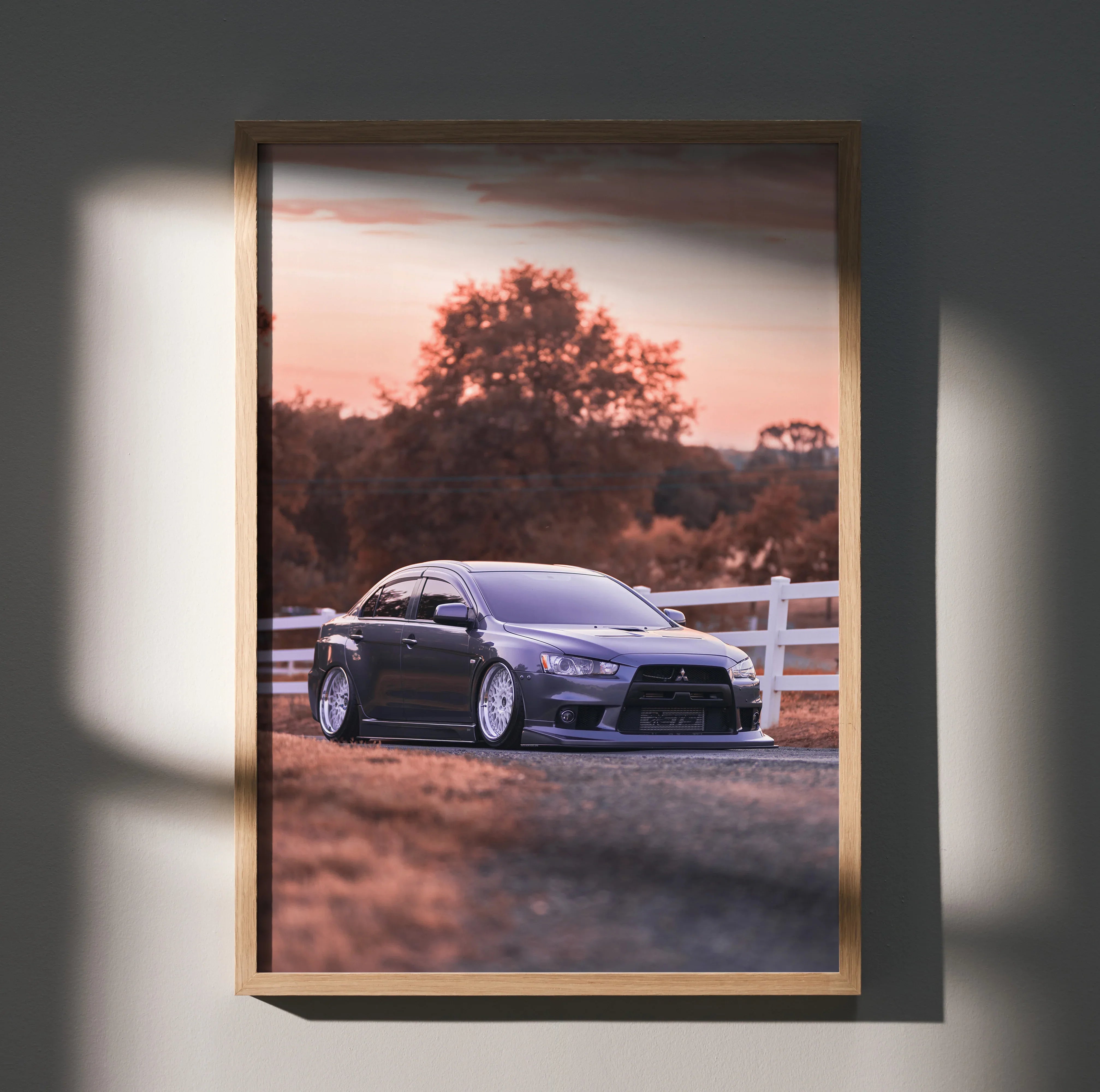 Mitsubishi Evo 10 in purple parked near white fence at sunset poster wall art.