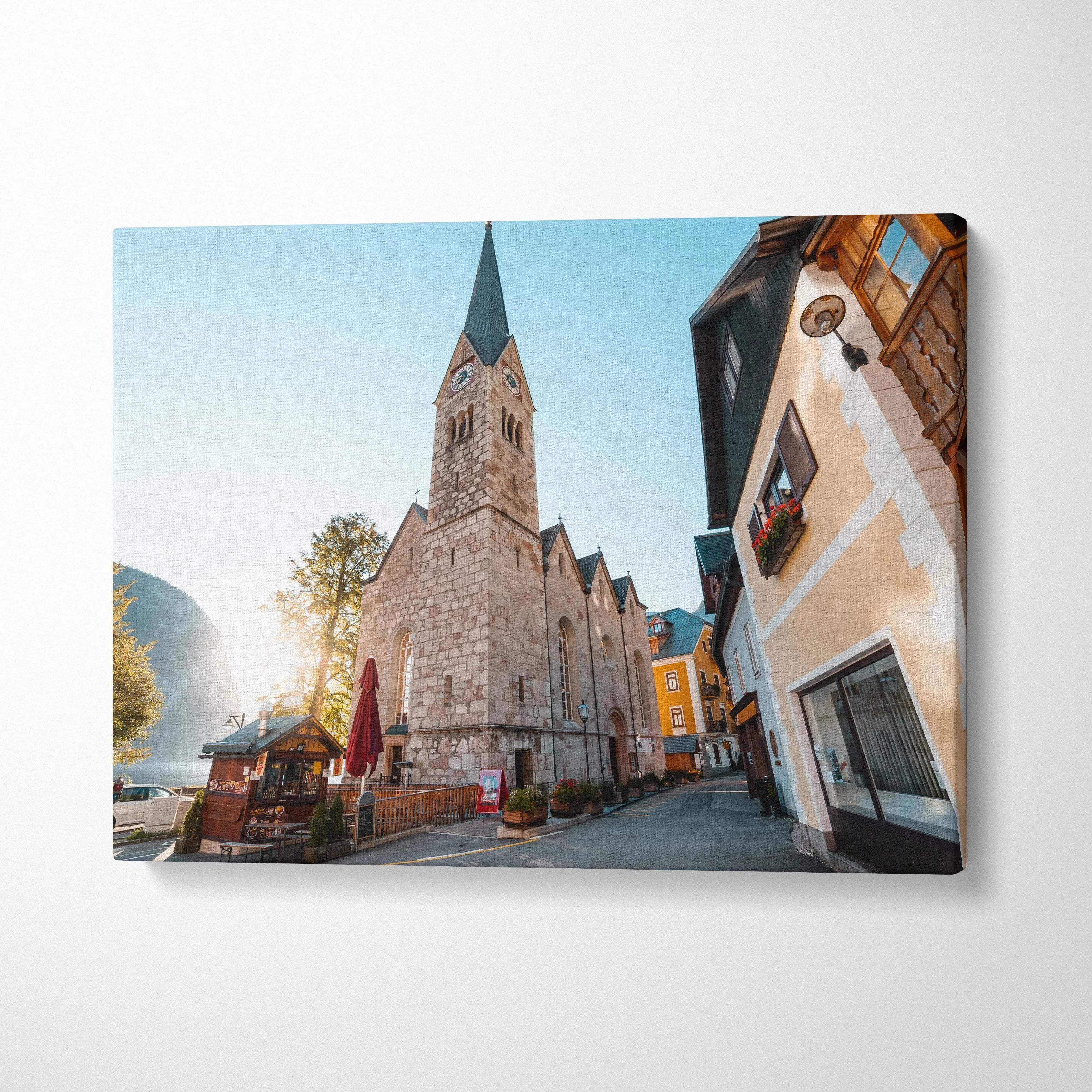 Canvas wall art featuring digital art of historic stone church and colorful buildings in bright daylight.