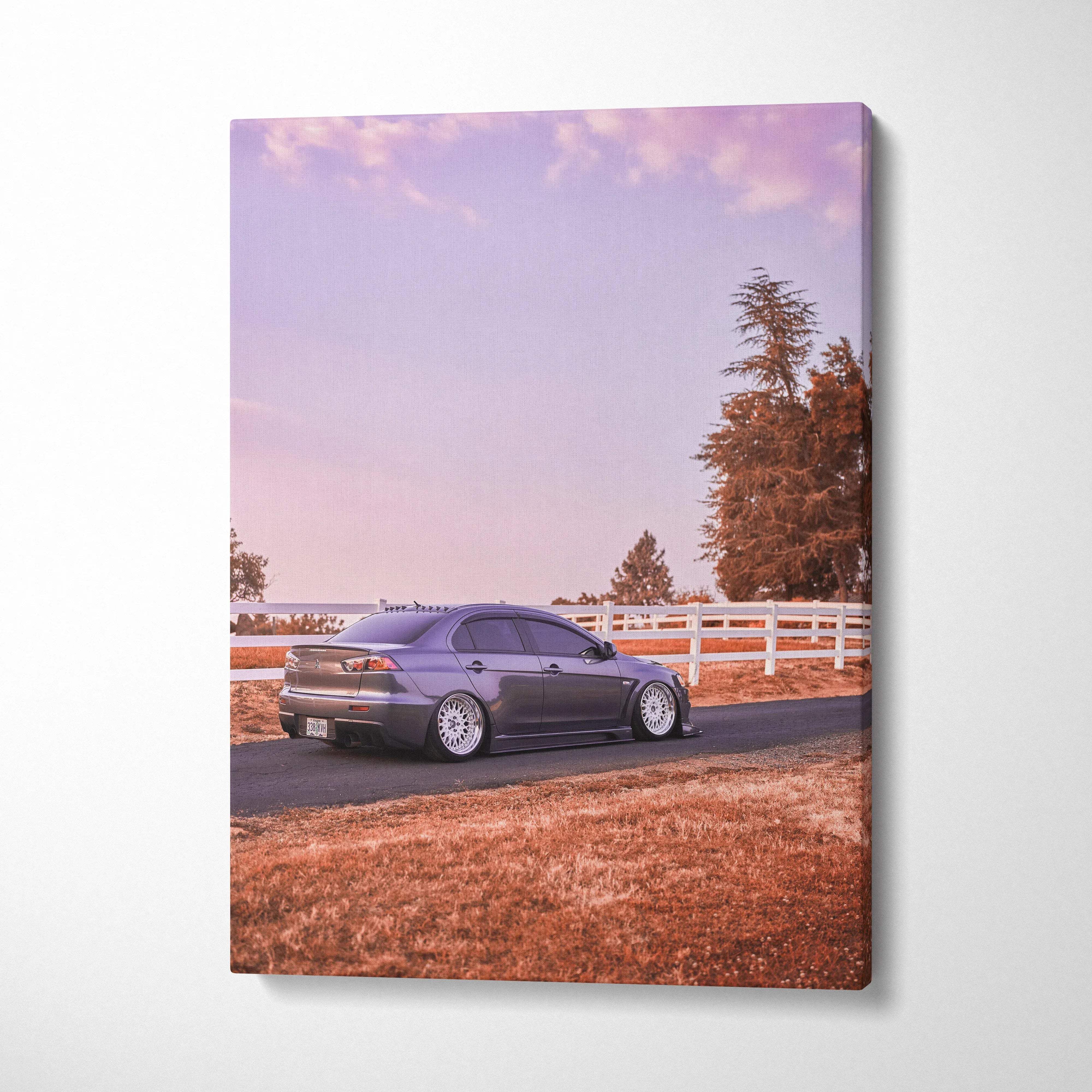 Mitsubishi Evo 10 parked on a road with white fence and trees during sunset vertical canvas wall art.