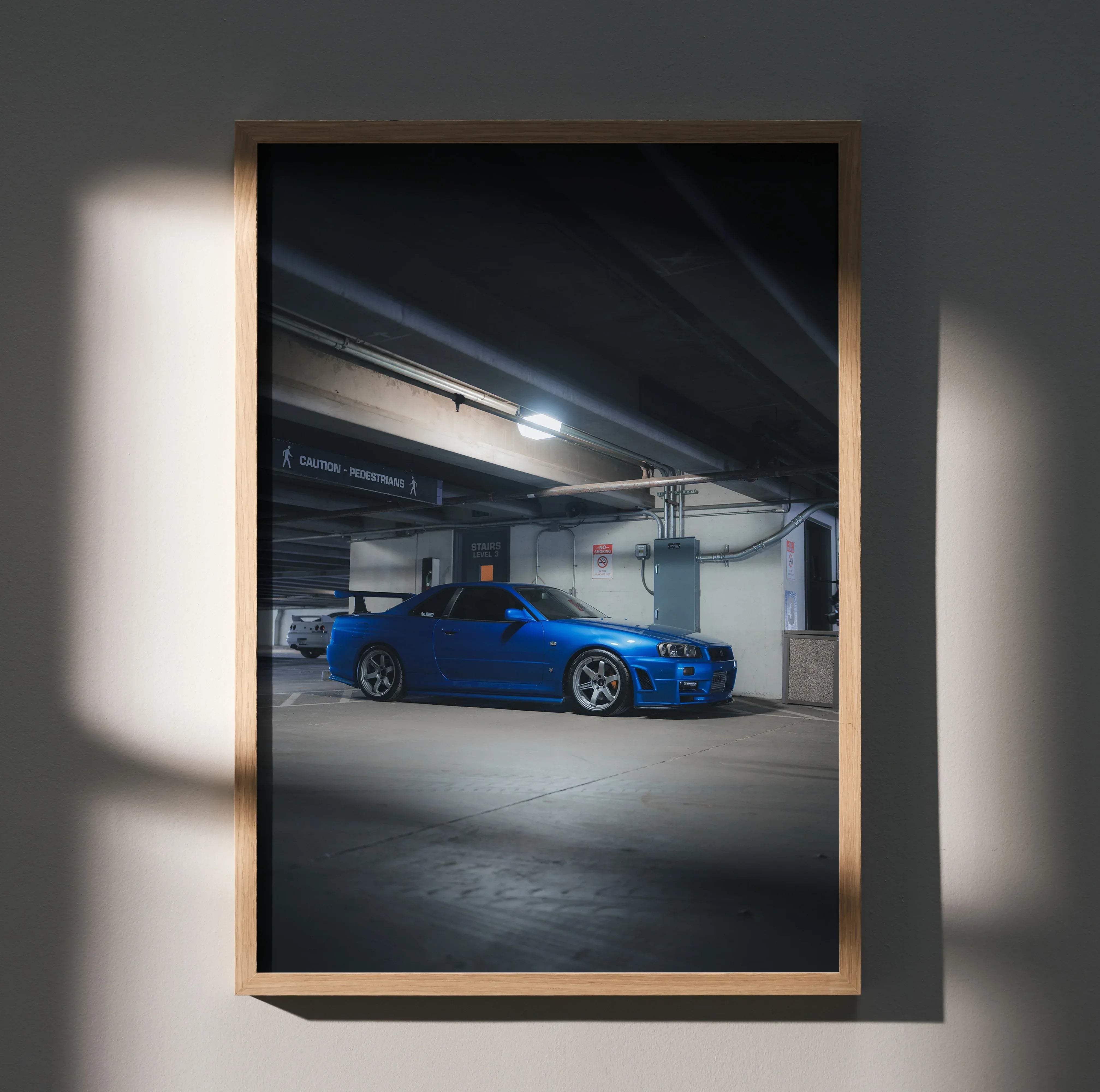Blue Nissan R34 GTR Skyline sports car poster in a light wood frame high resolution for wall decor