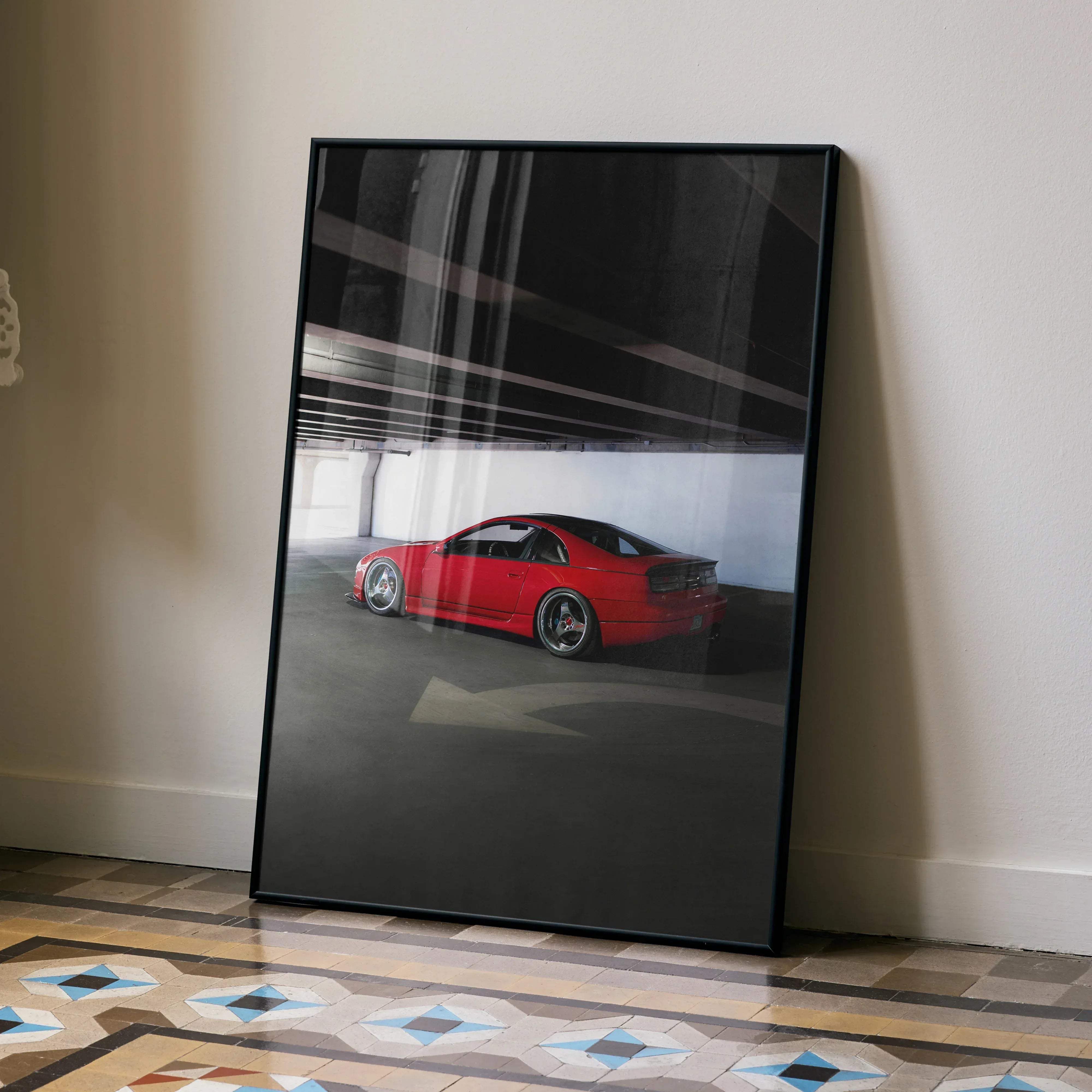 A framed black and white photograph poster featuring a vibrant red nissan 300zx skyline sports car with custom alloy wheels
