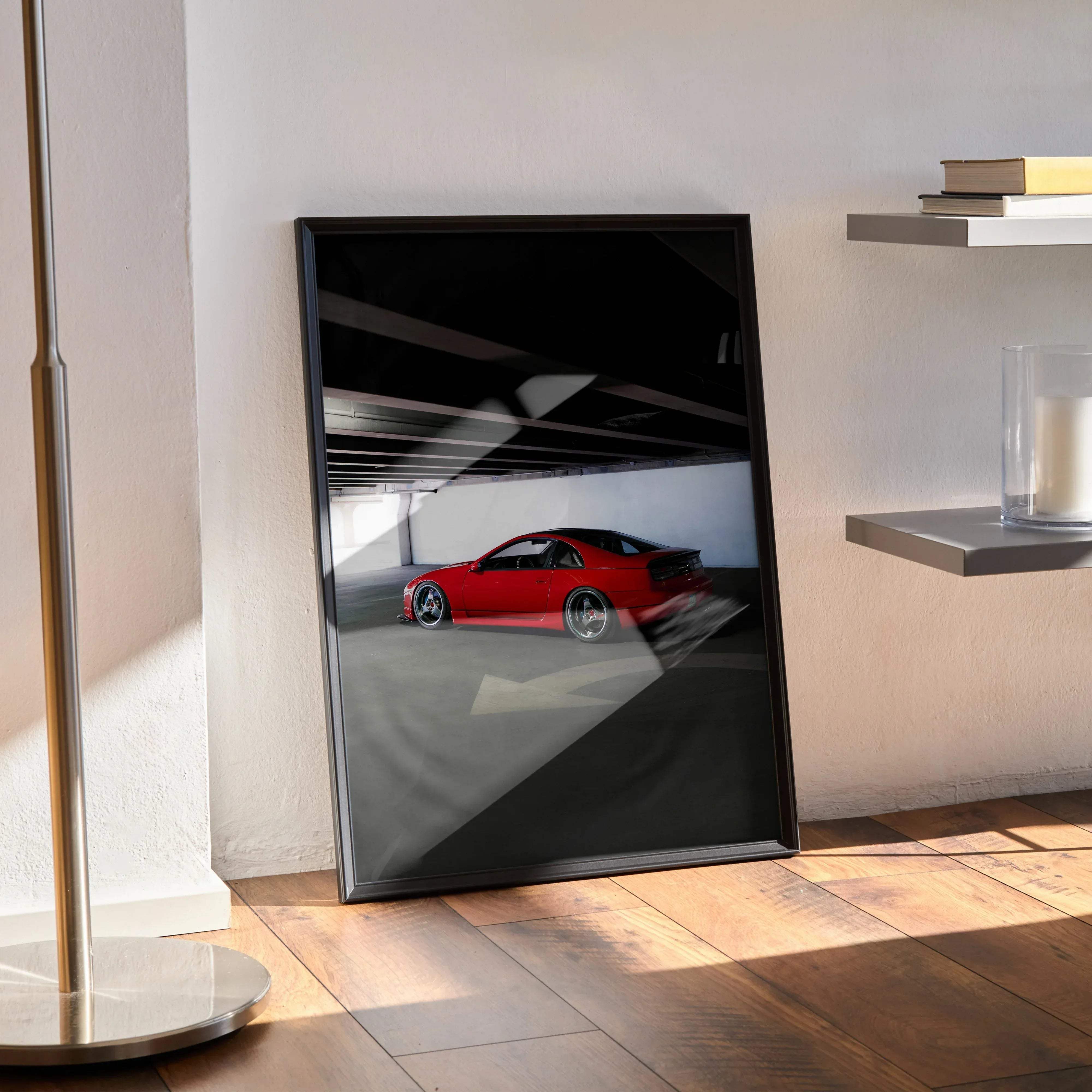 Black-framed art print of a vibrant red nissan 300zx skyline sports car in motion inside a dimly lit garage