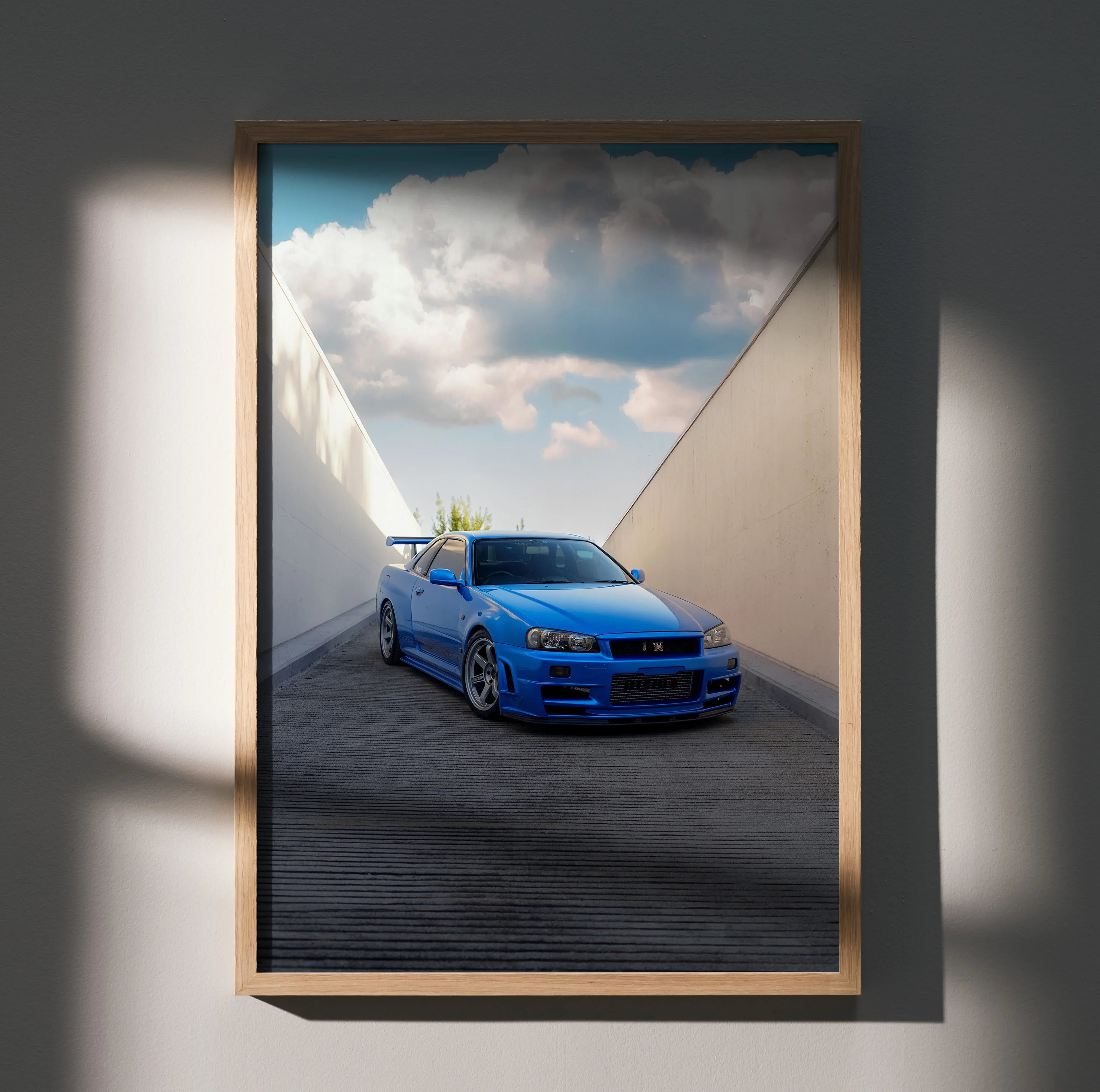 Nissan R34 GTR Skyline in bright blue driving through minimalist tunnel wall art poster.
