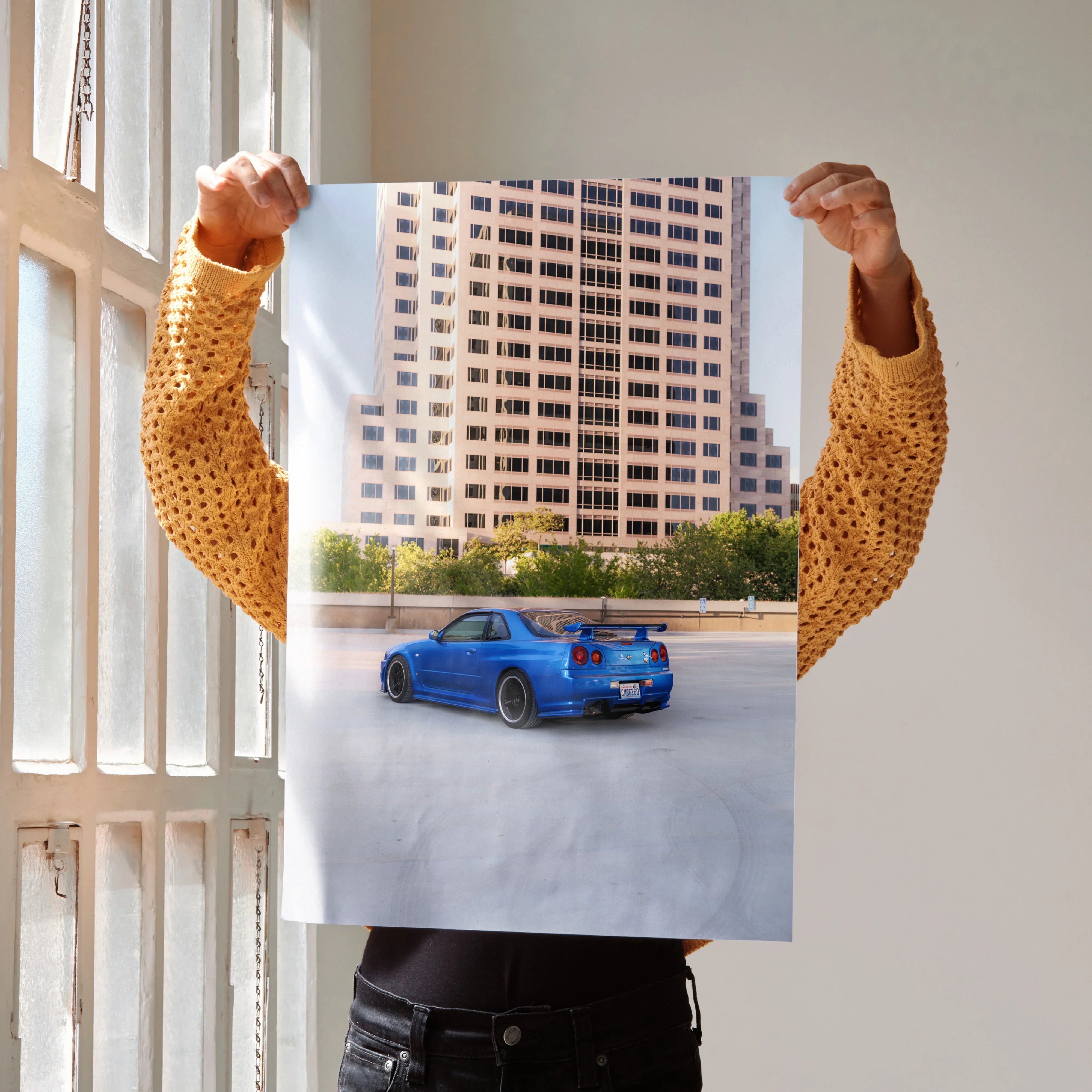 Nissan R34 GTR blue sports car poster with city skyline background wall art.