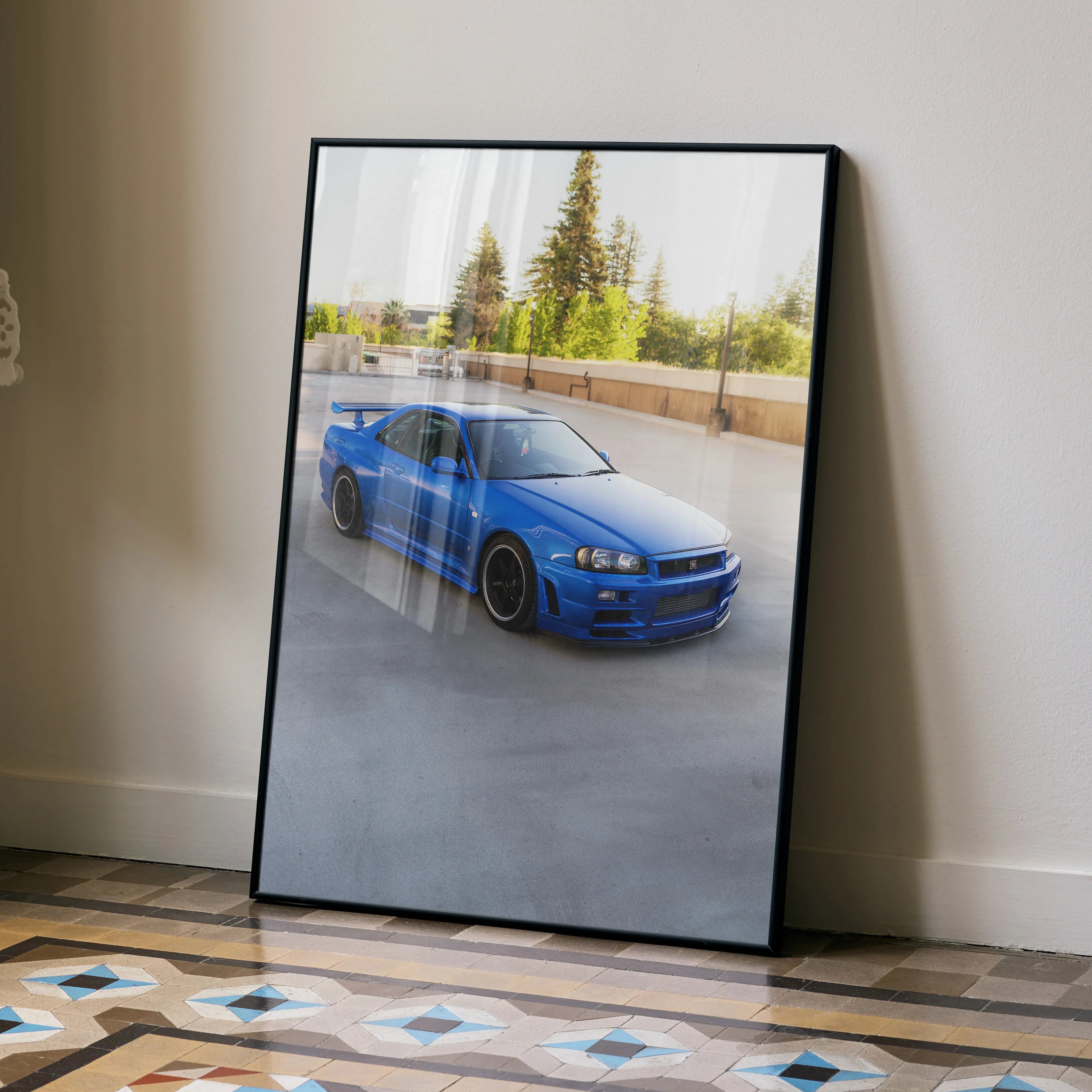 Nissan R34 GTR Skyline poster featuring blue car against blurred outdoor background wall art.
