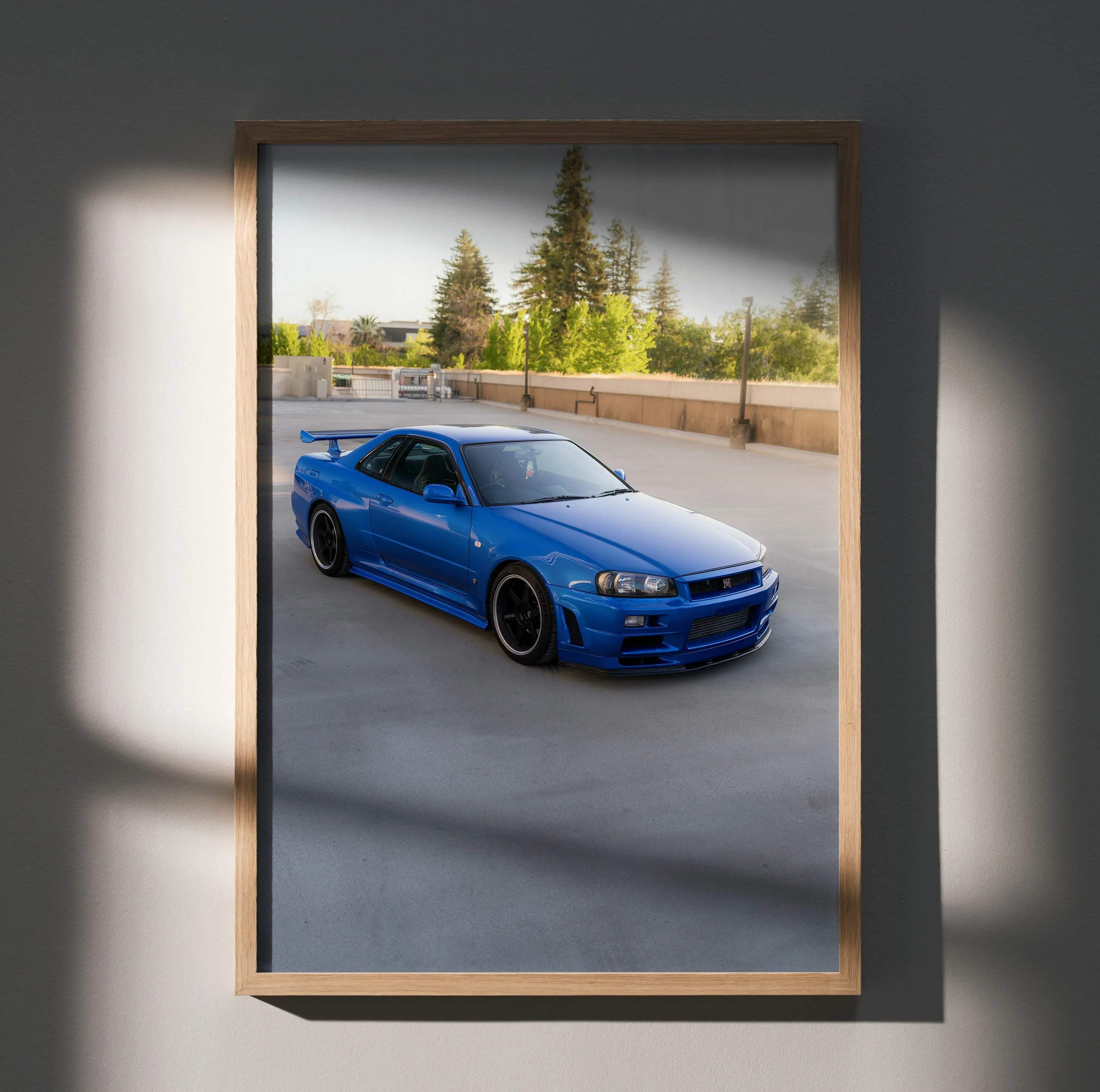 Blue Nissan R34 Skyline GTR sports car high resolution poster in a light wood frame for wall decoration