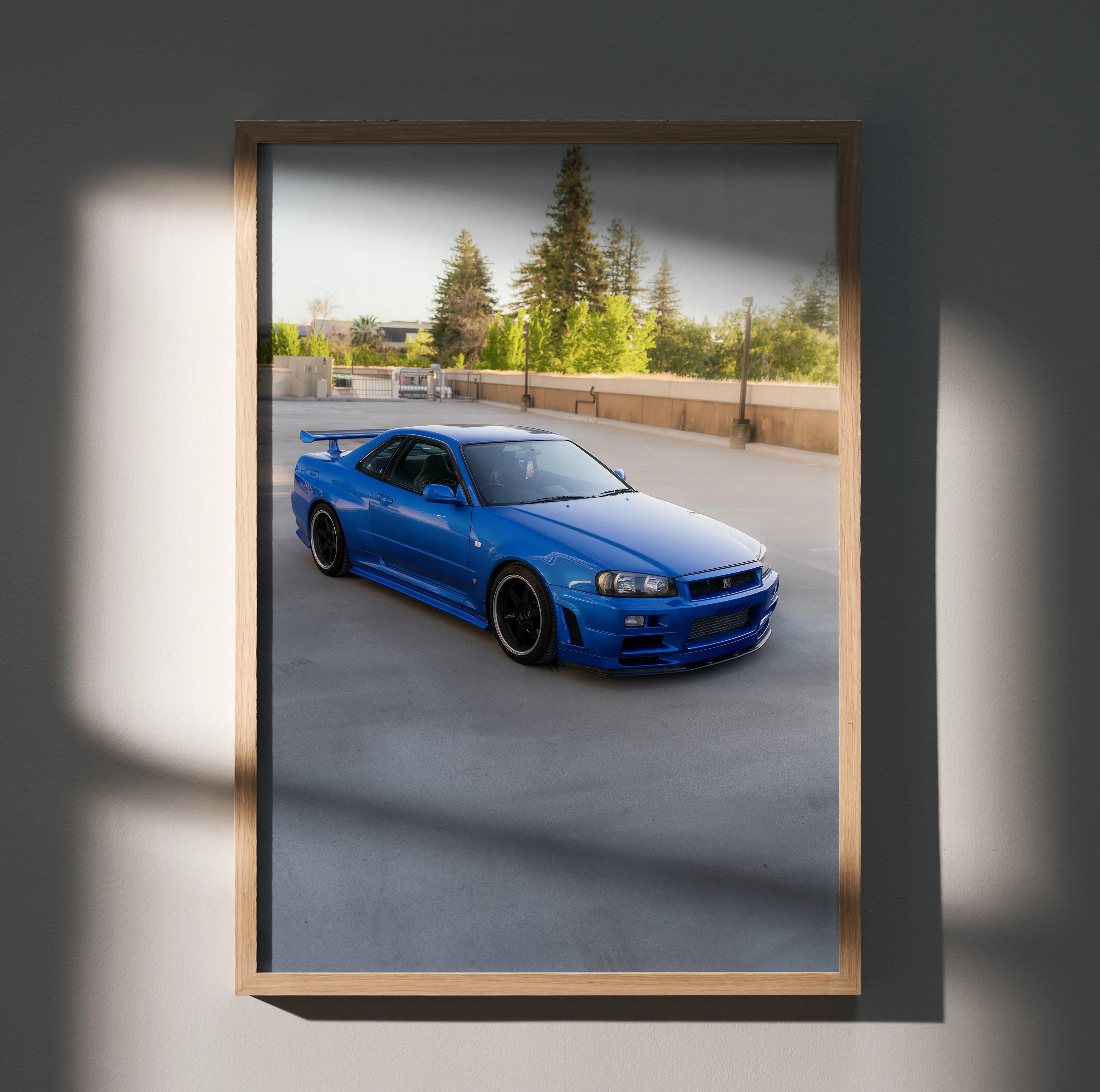 Nissan R34 GTR Skyline in blue on rooftop parking lot poster wall art in wooden frame.