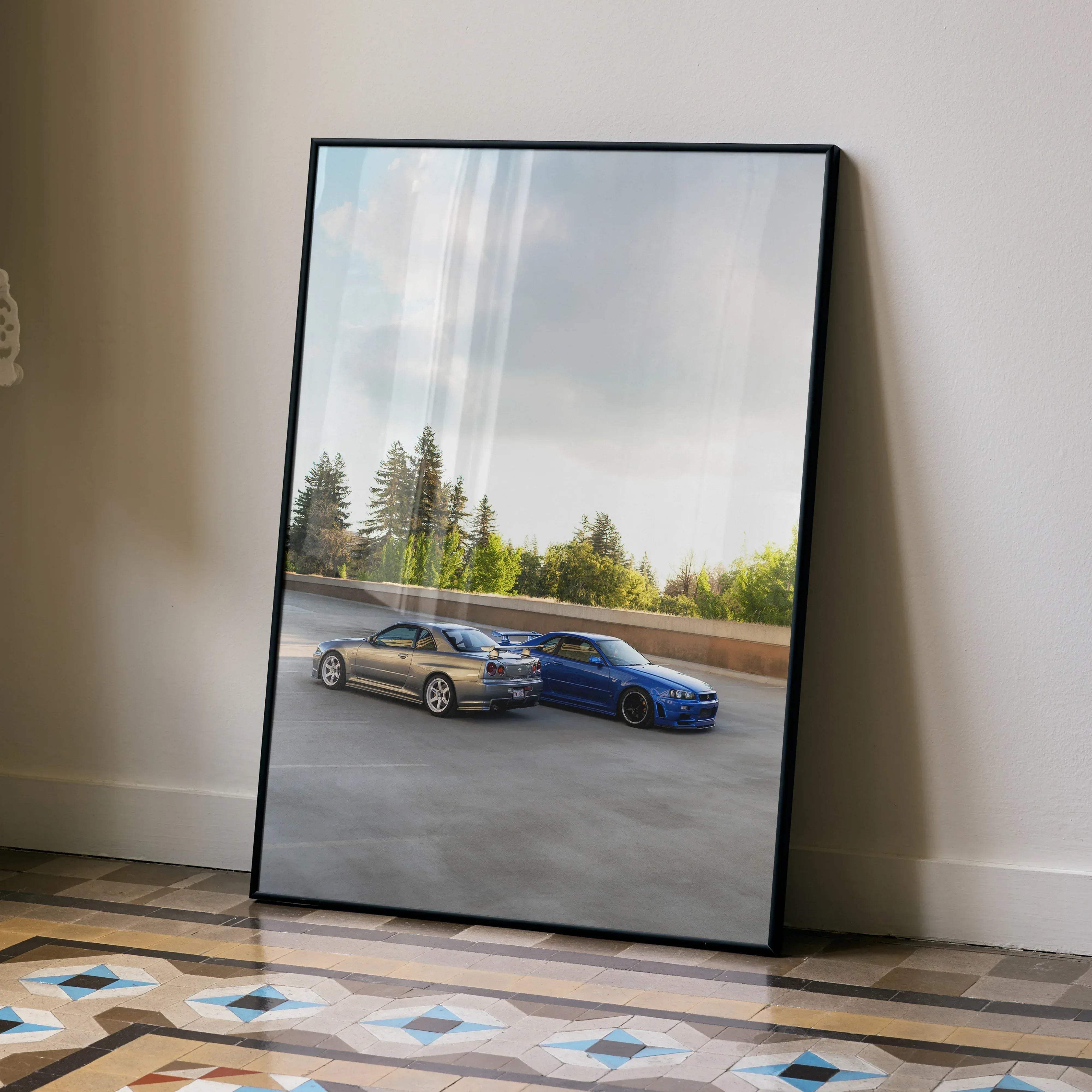 Black-framed poster of two nissan skyline r34 gt-rs in metallic gold and vibrant blue high resolution design