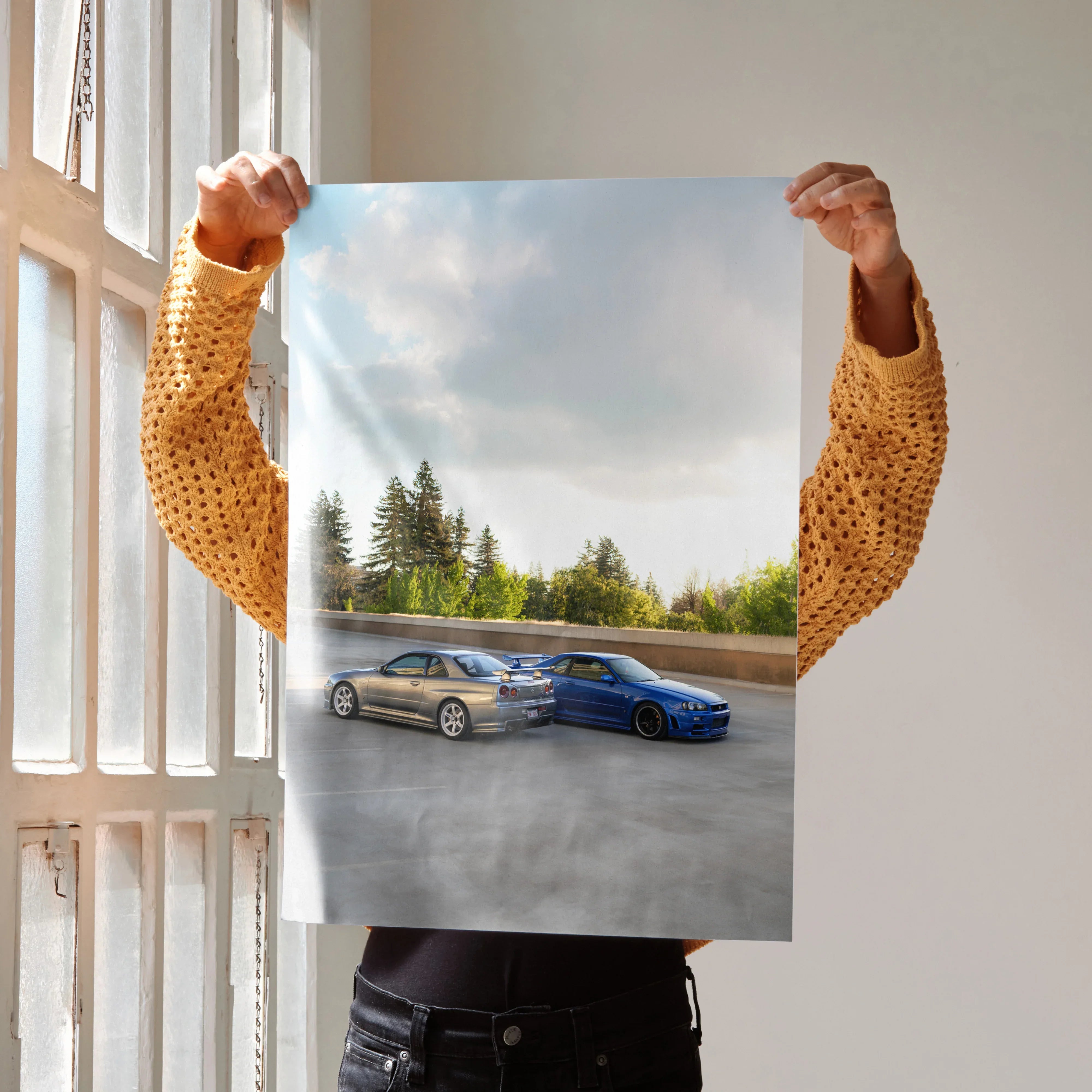 Nissan R34 GTR Skyline poster showing two cars against a sunset sky, wall art option.