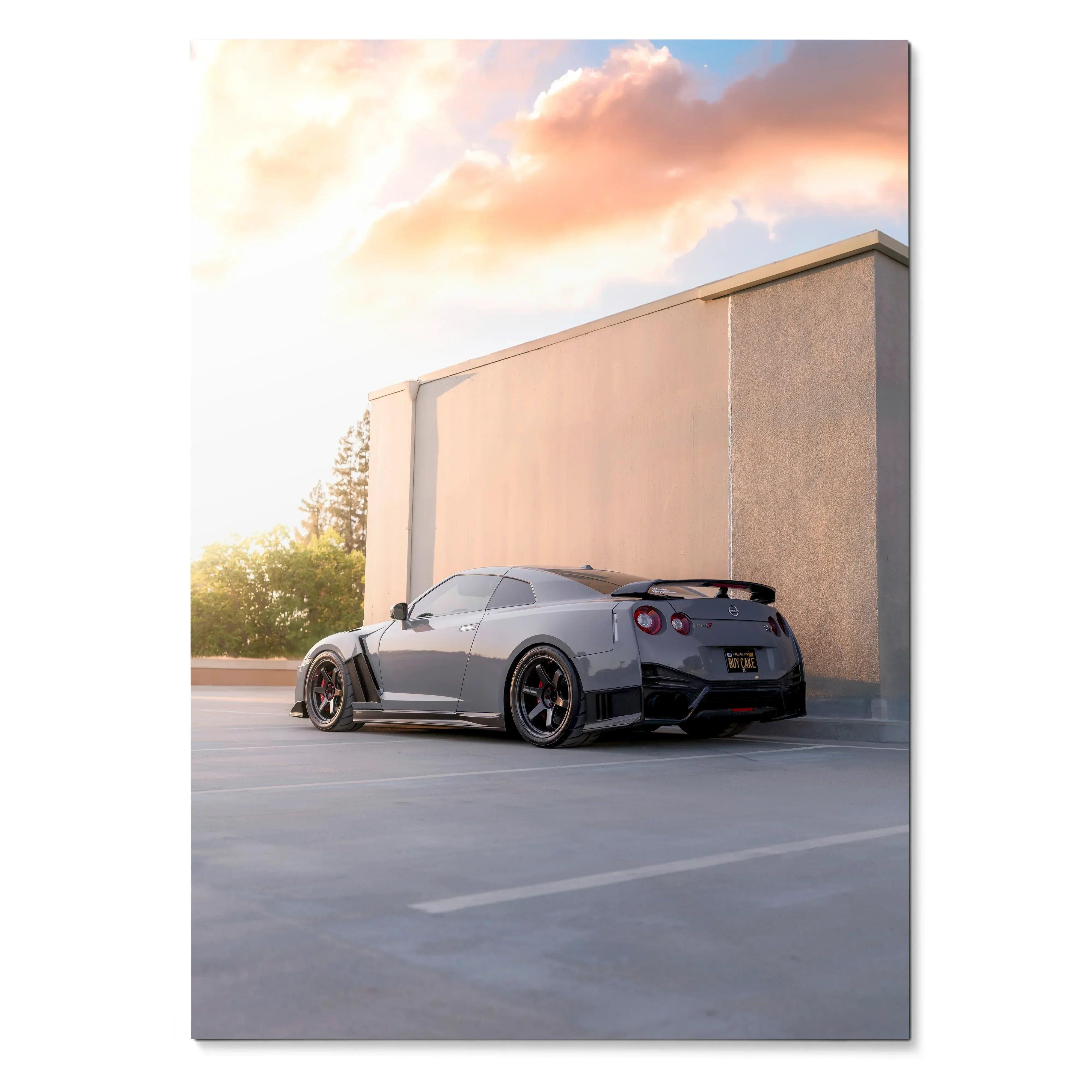 Nissan GTR R35 parked near a beige industrial wall at sunset poster wall art.