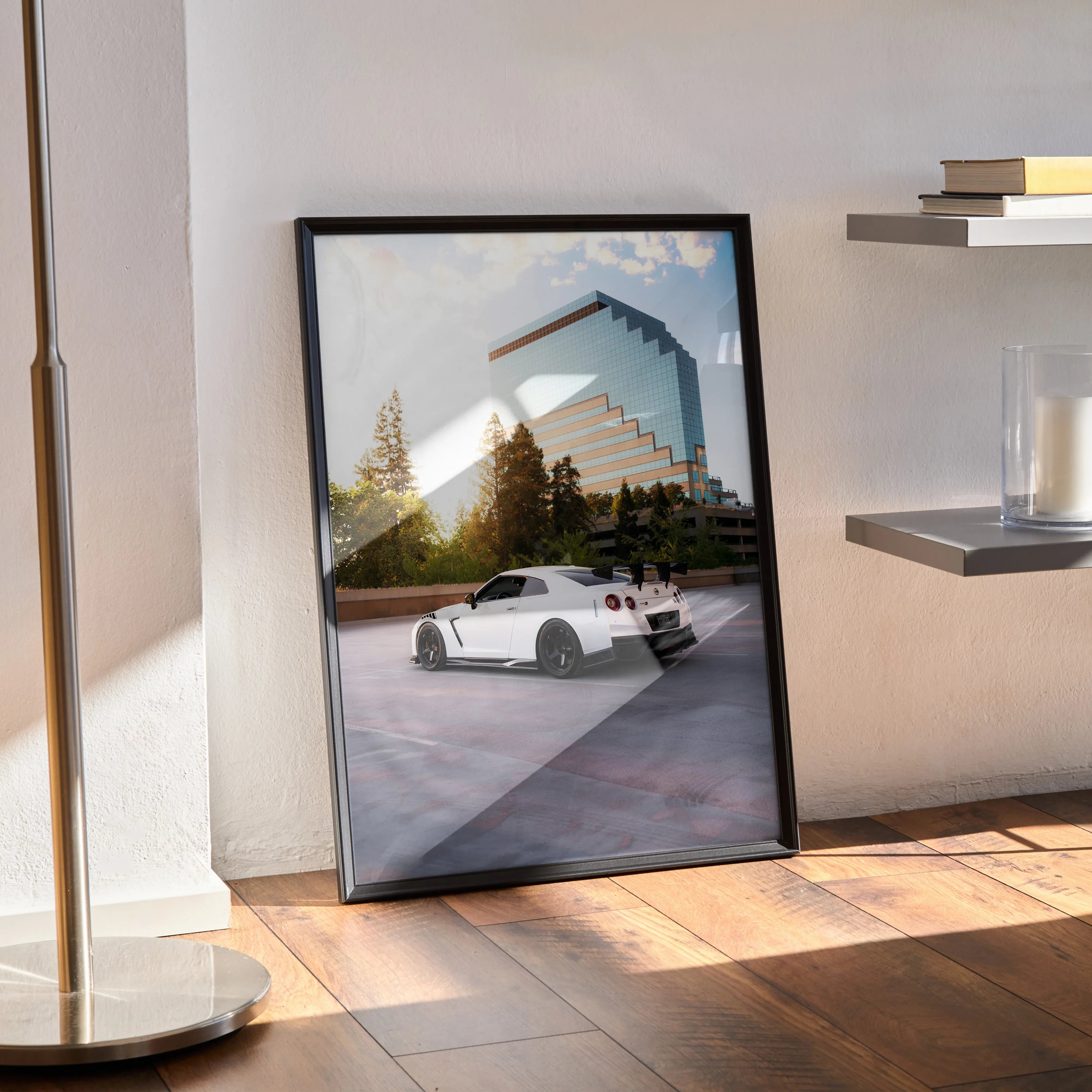 Nissan GTR R35 poster wall art with white sports car in urban setting framed in black.