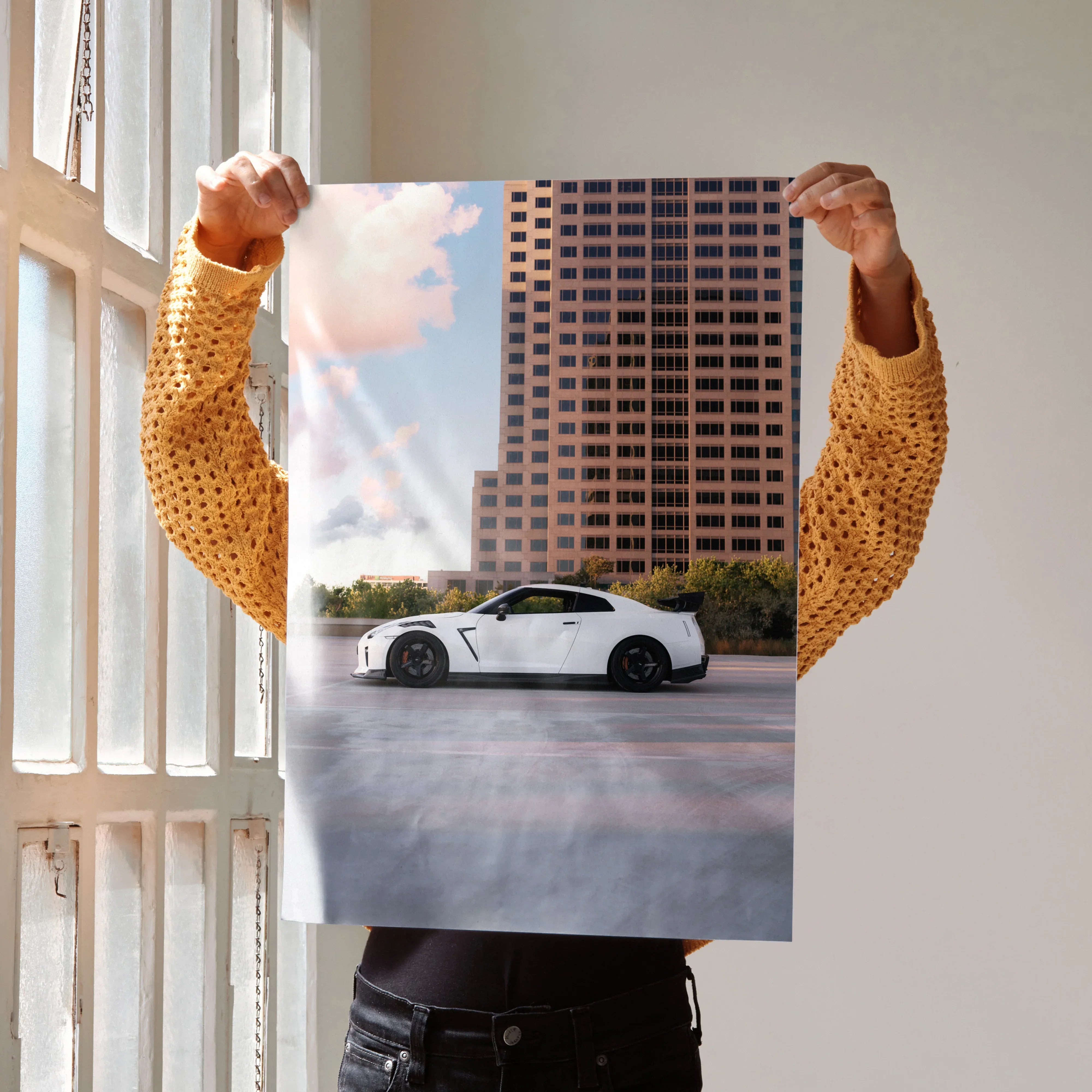 Nissan GTR R35 parked in front of a tall building at sunset, high resolution car poster wall art.