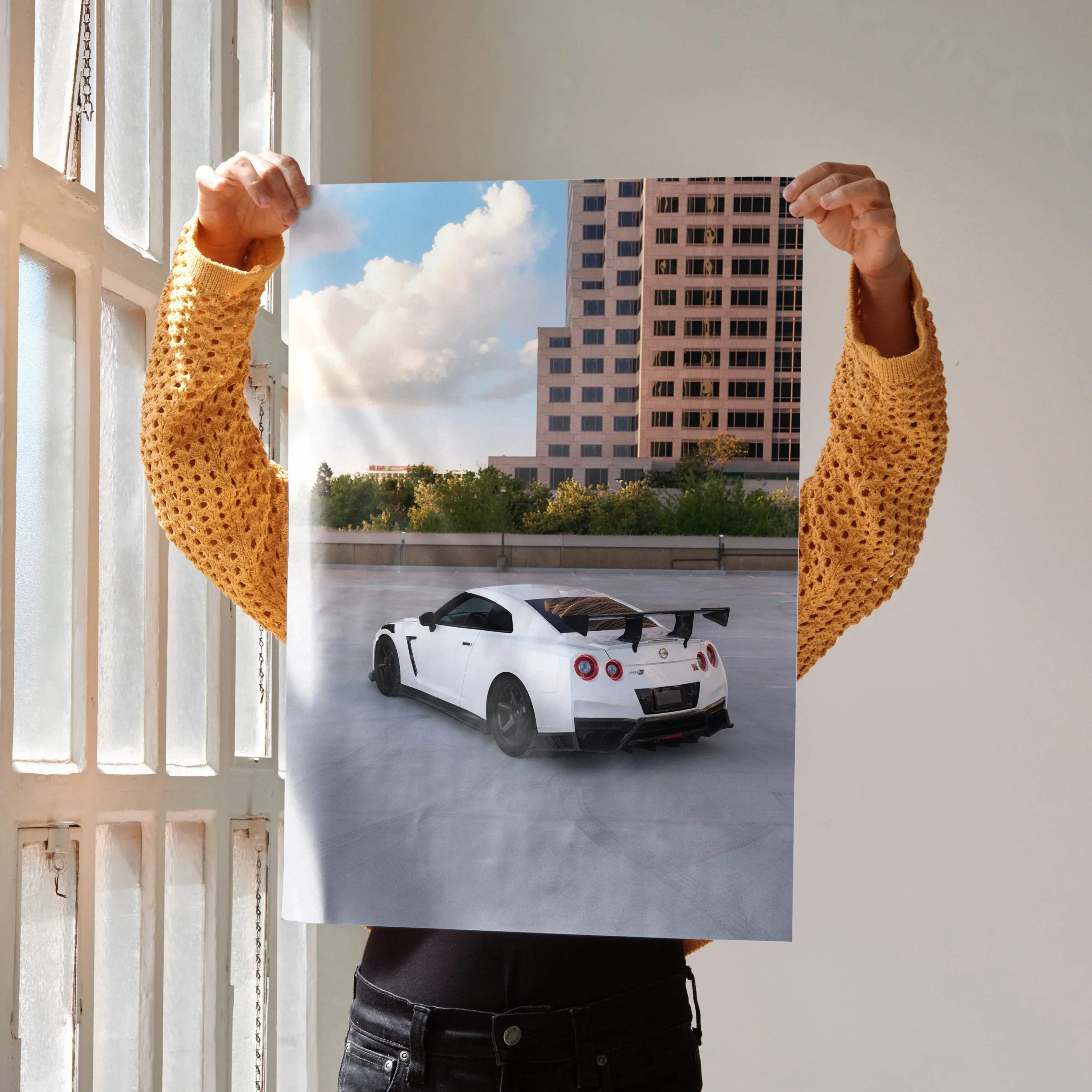 White nissan gtr r35 sports car poster showing detailed rear view with glossy finish, spoiler, red taillights, and black rims