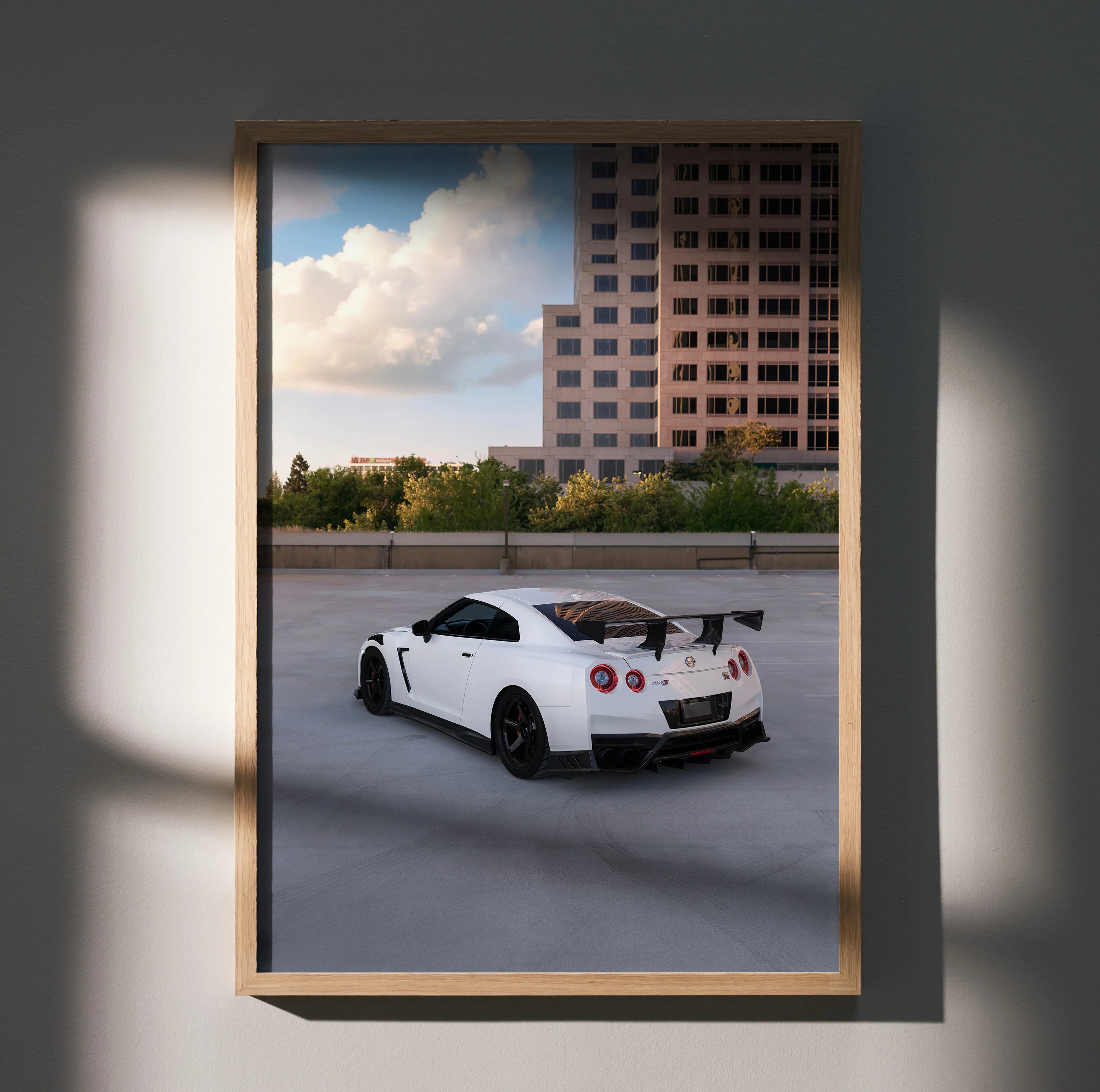 Nissan GTR R35 white sports car parked on rooftop at sunset poster wall art.