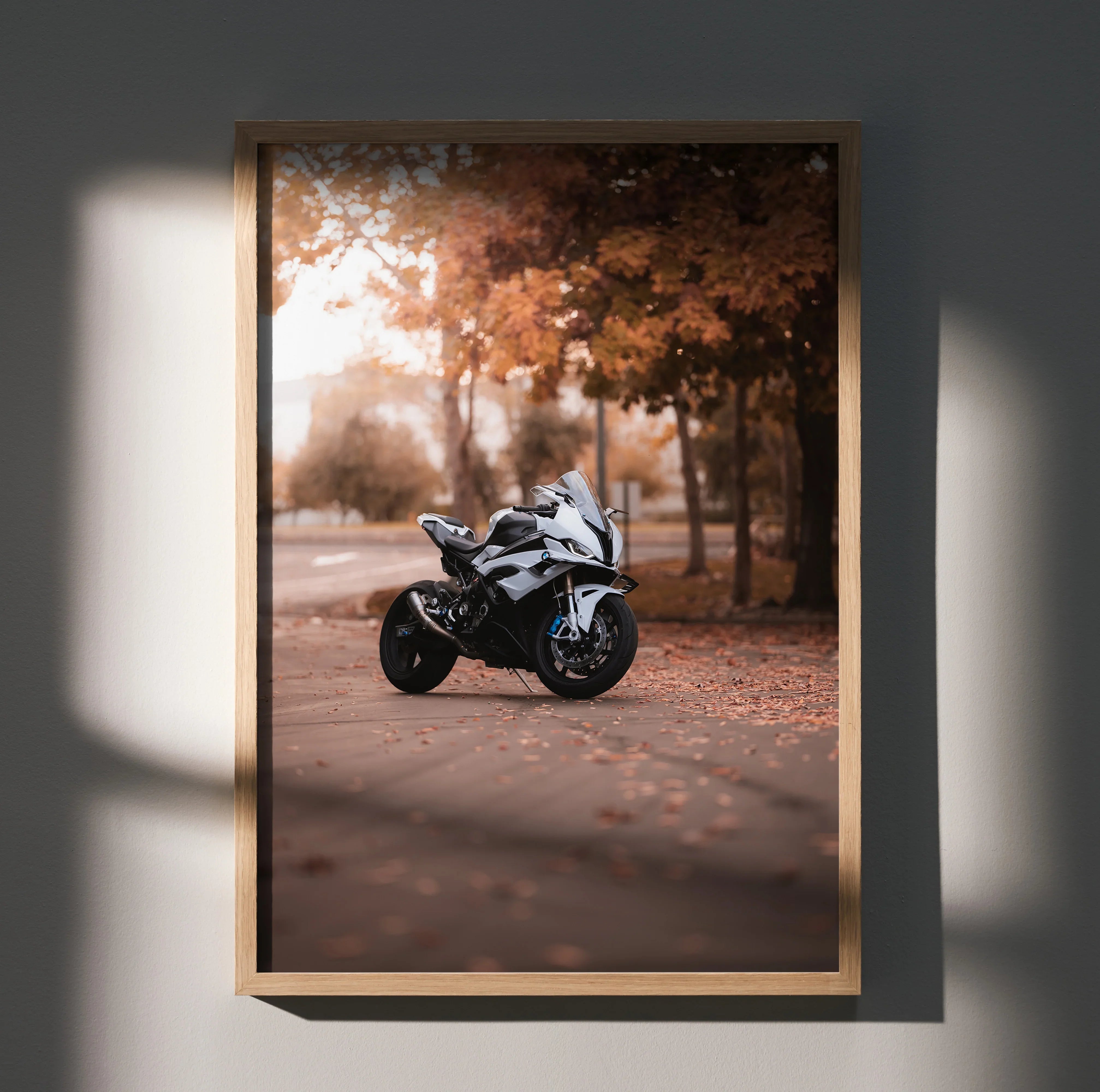 BMW S1000RR motorcycle poster with autumn leaves background as wall art in wooden frame.