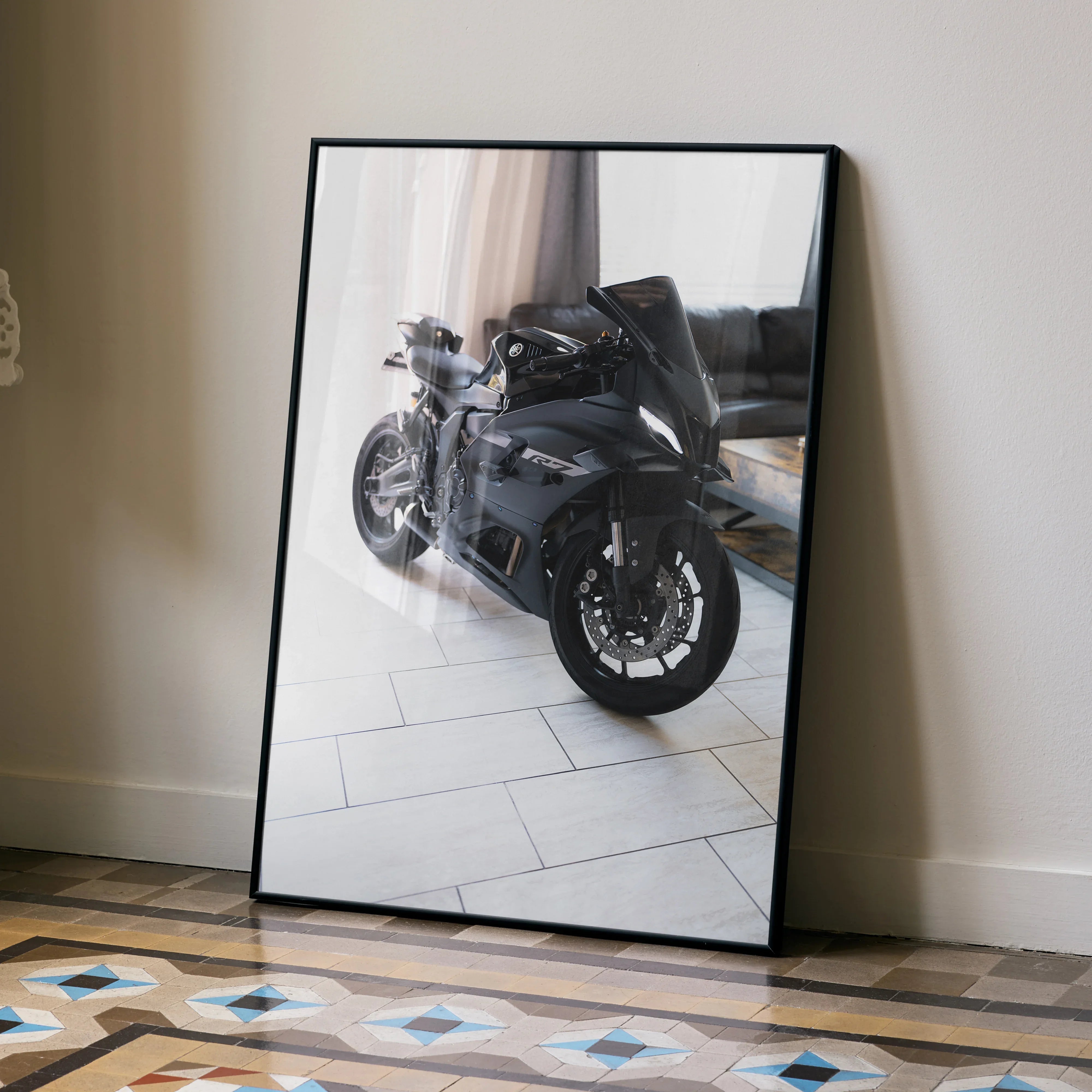 Yamaha R7 motorcycle poster in sleek black frame leaning on floor, modern wall art with reflective glass.