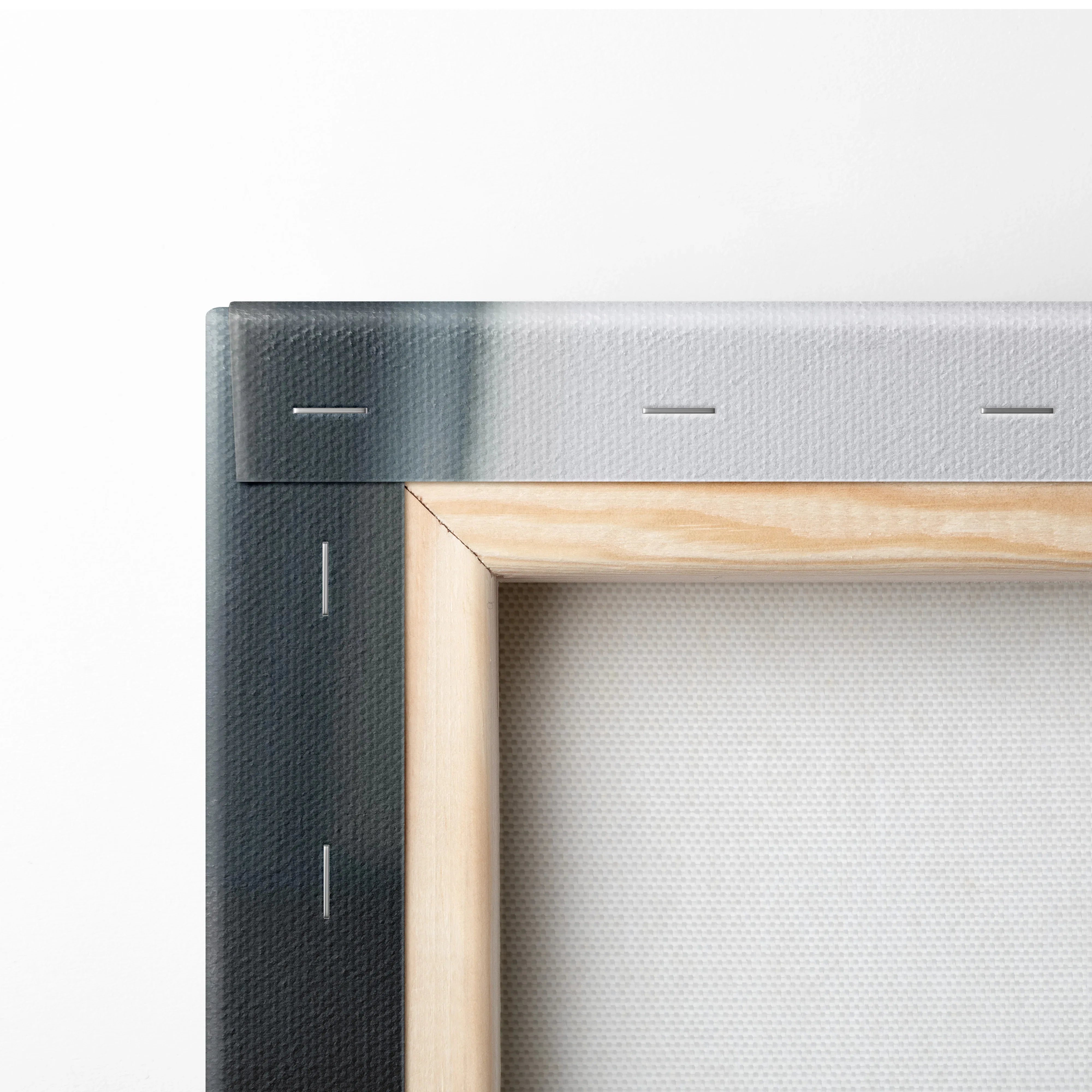 Close-up of wooden frame corner and stapled stretched canvas for high-resolution wall art print.