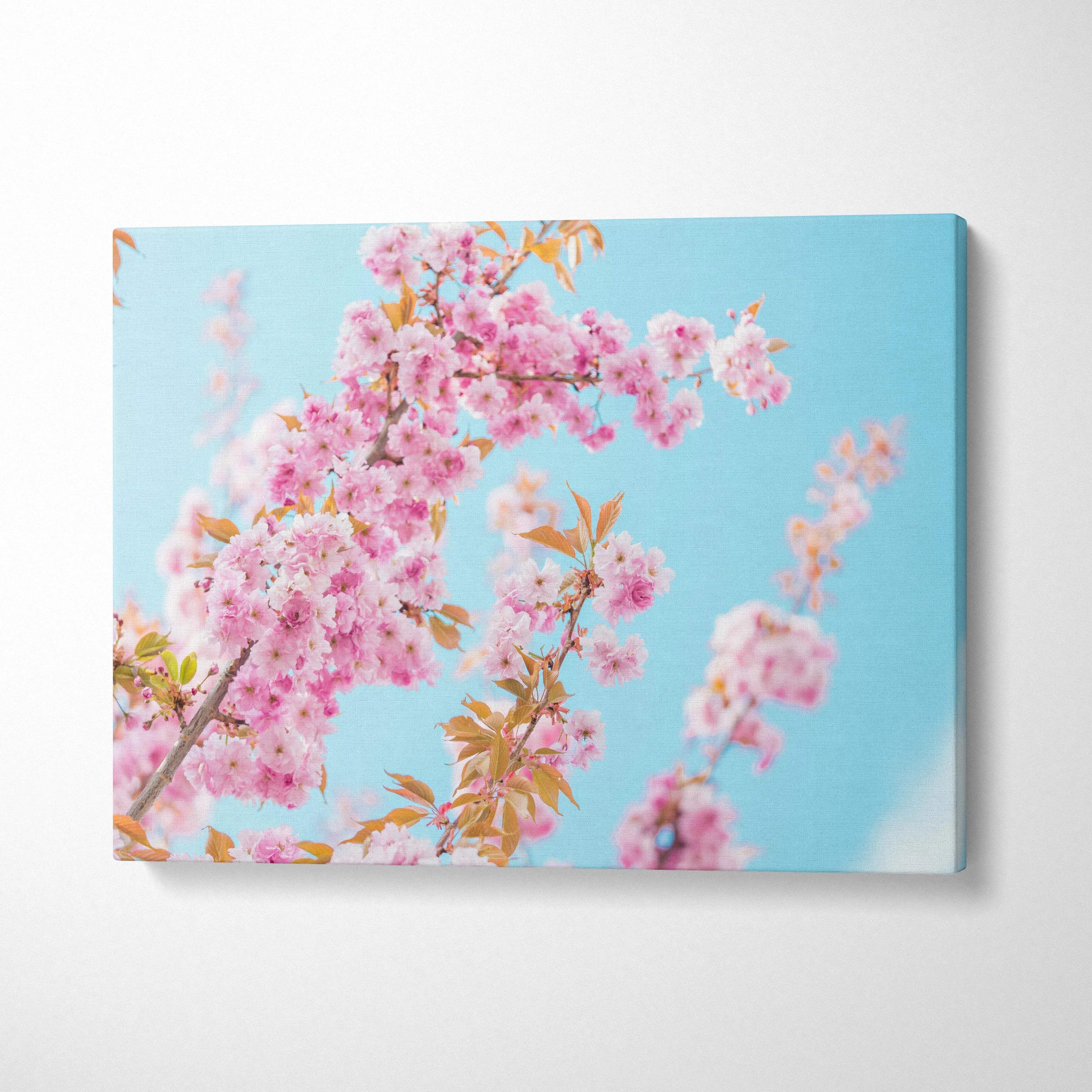 Vibrant pink flowers floral canvas wall art with bright blue sky background for elegant home decor.