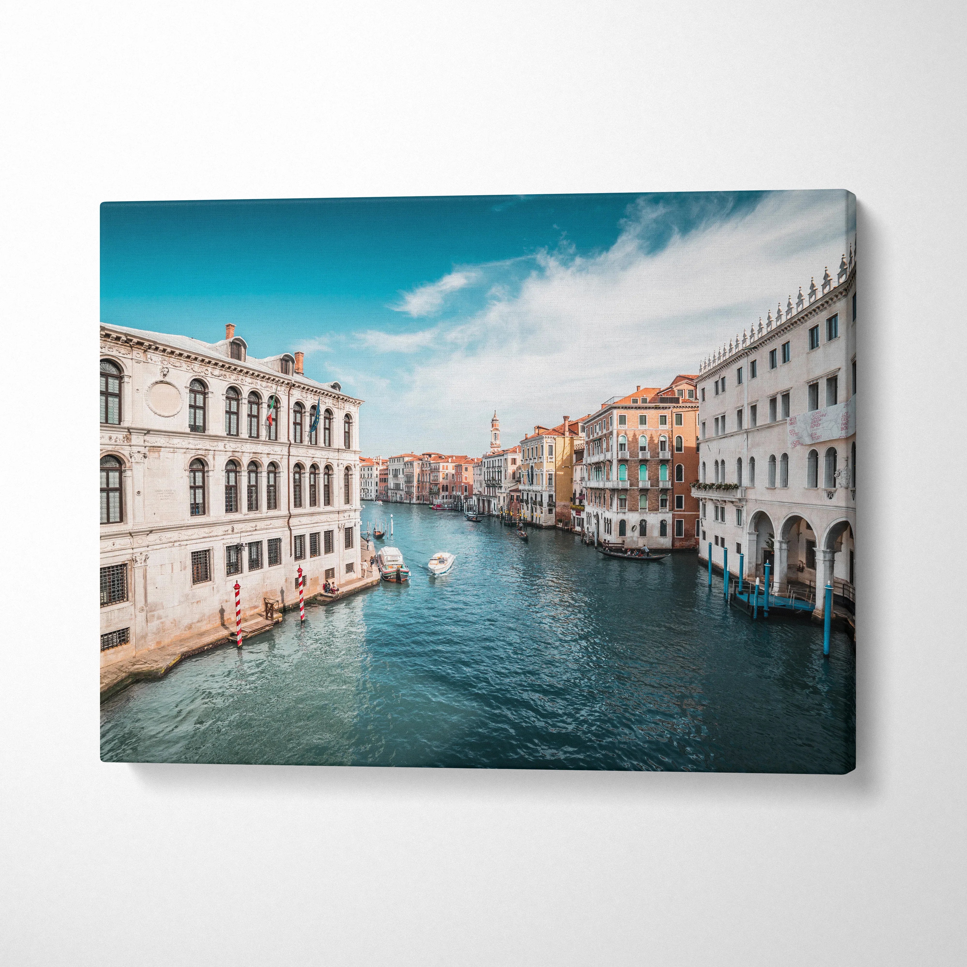 Canvas wall art of colorful buildings lining an ocean canal under a bright blue sky.