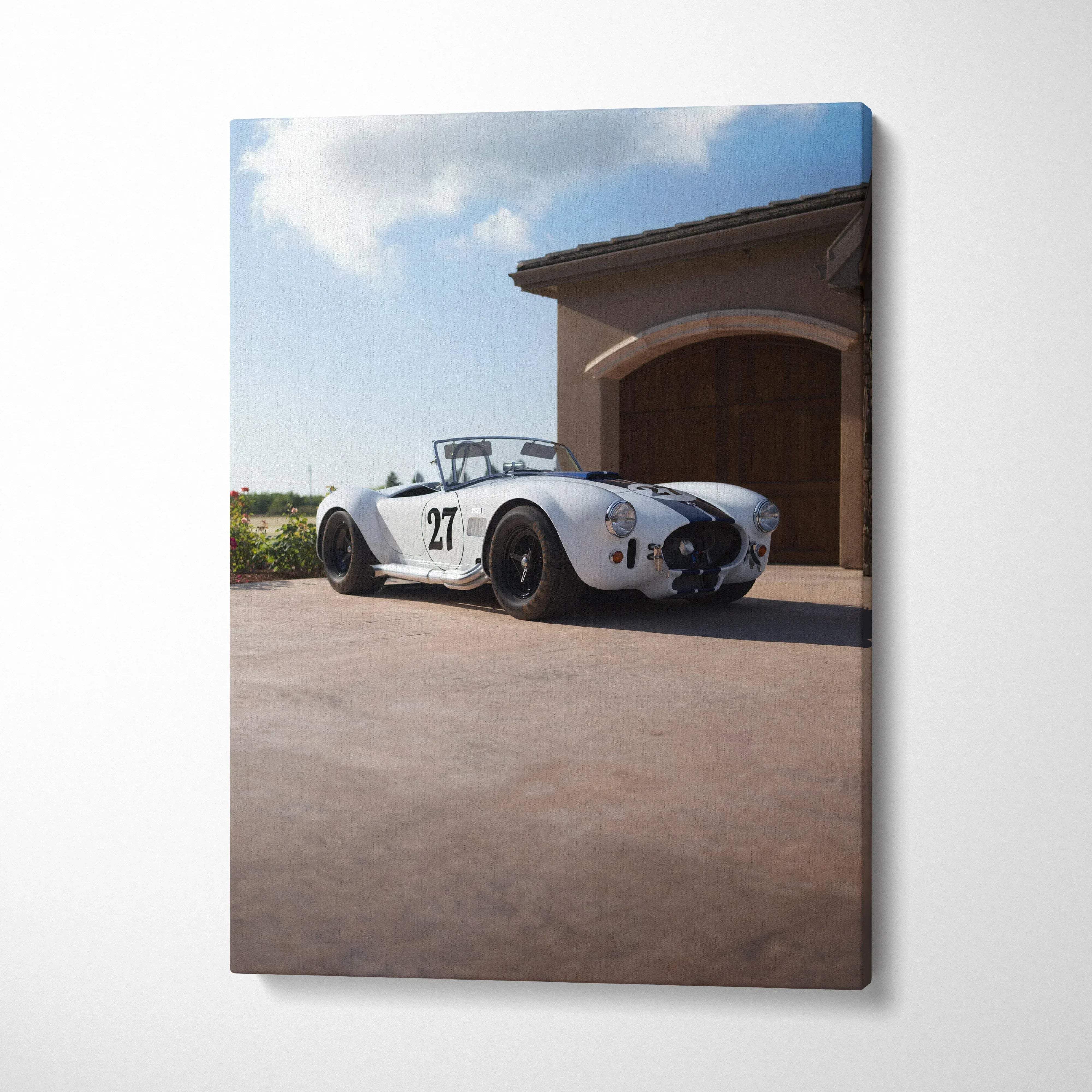Canvas wall art featuring a white and black vintage shelby cobra race car with number 27 on driveway background