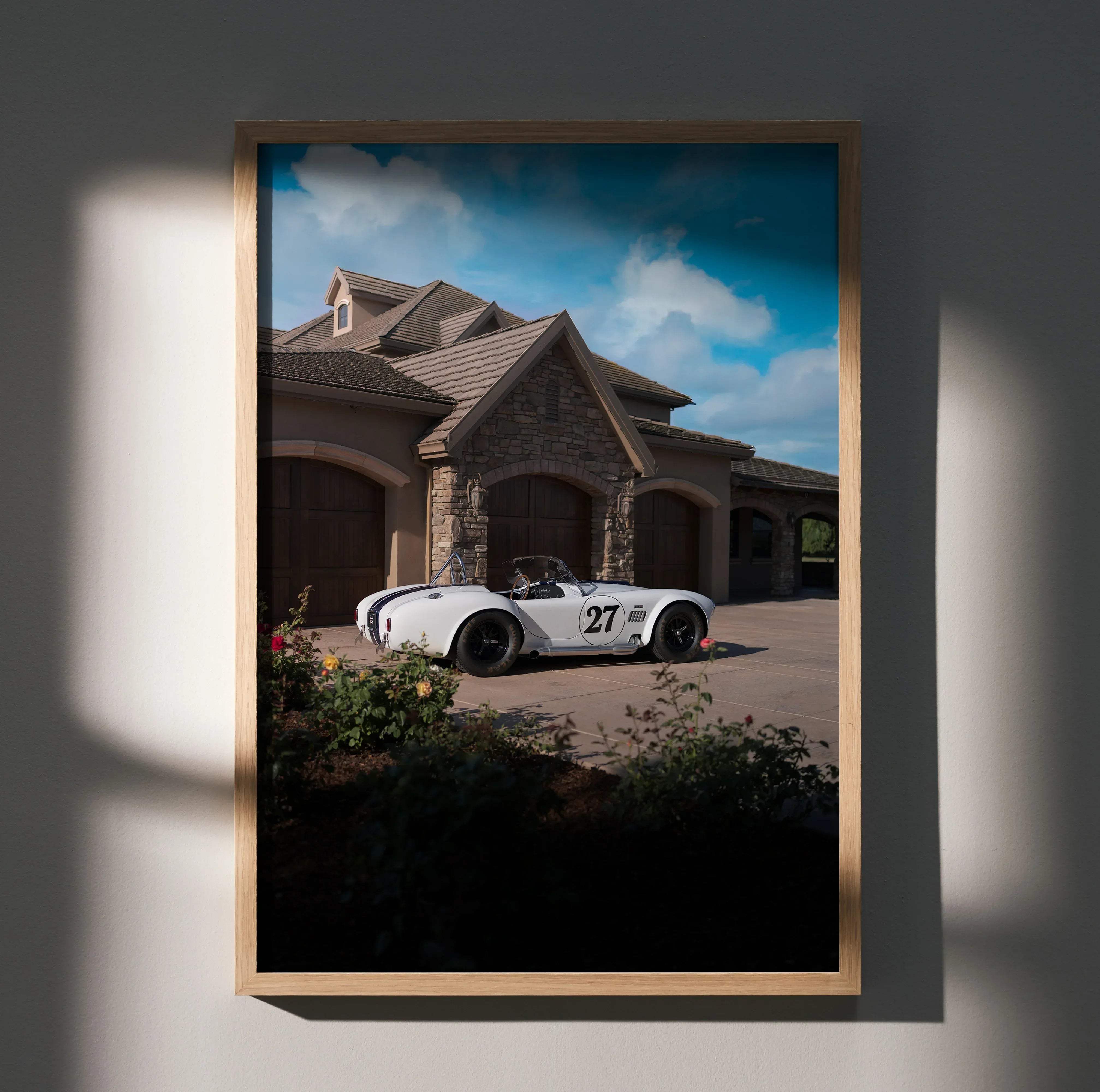 Shelby cobra high resolution car poster of white vintage race car with black stripes and number 27 in light wood frame