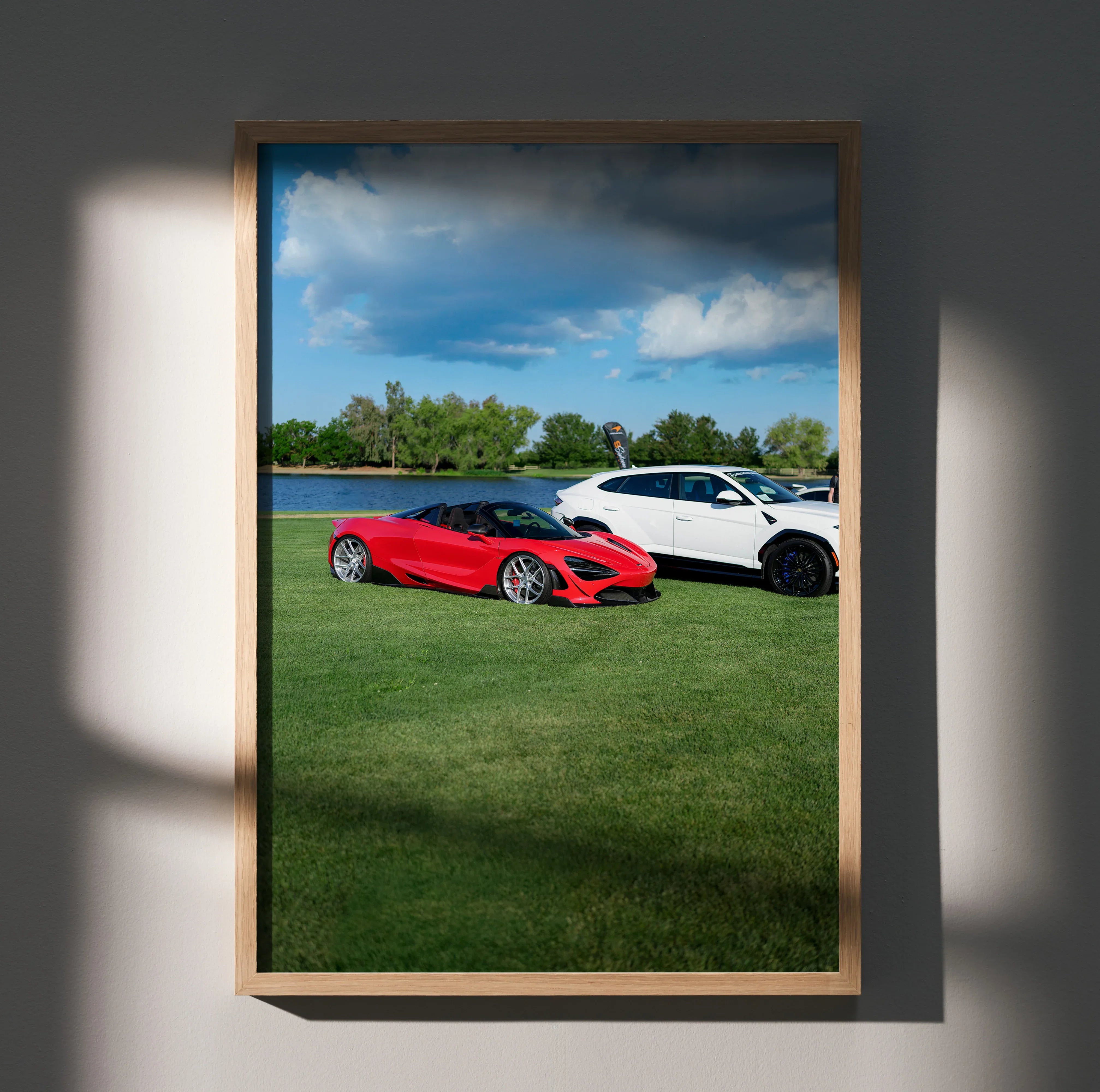 McLaren 720S red and white cars on green lawn under blue sky poster wall art.