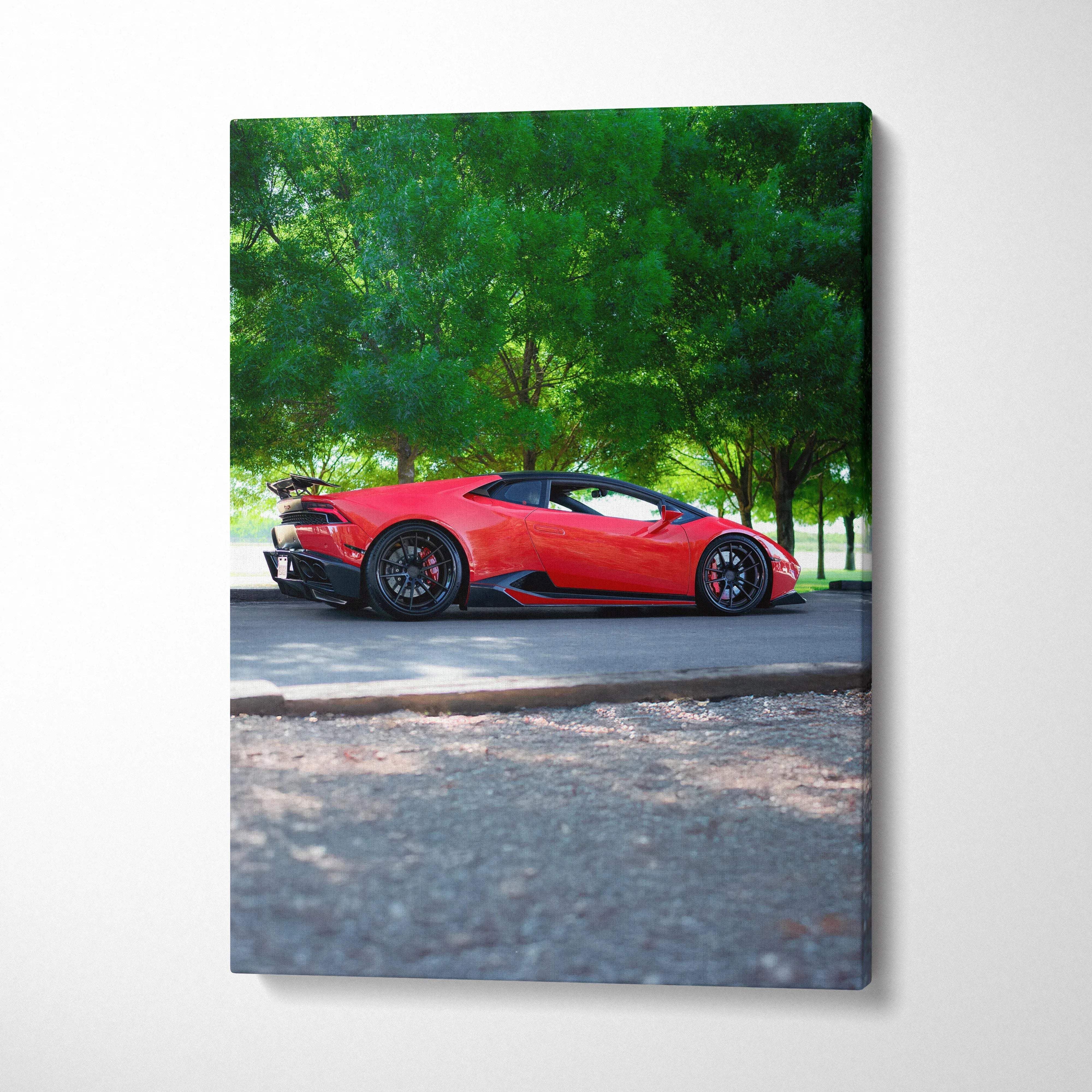 Red Lamborghini Huracan parked on road under green trees canvas wall art print.