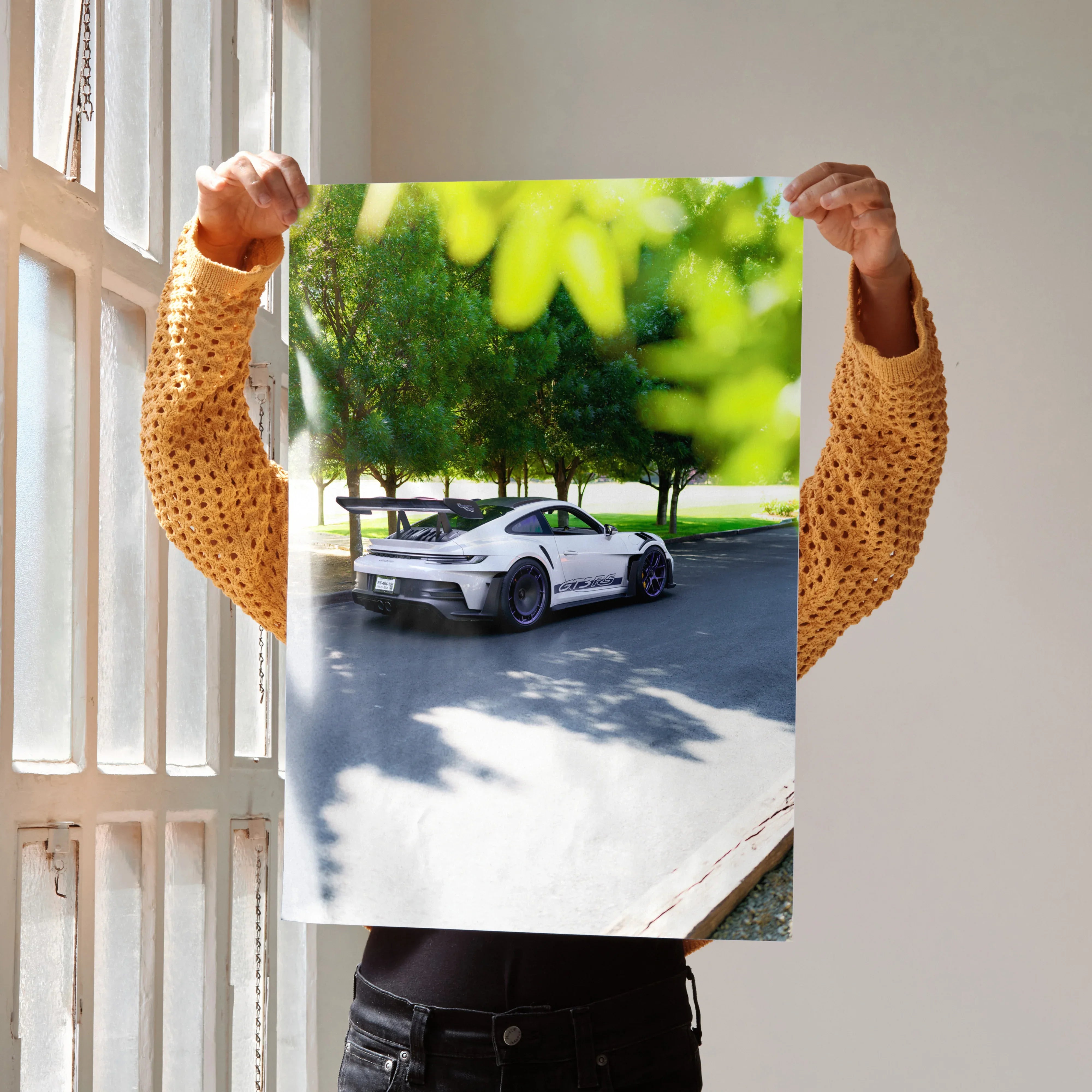 Porsche 911 GT3 RS poster with white car and green trees as wall art in natural light.