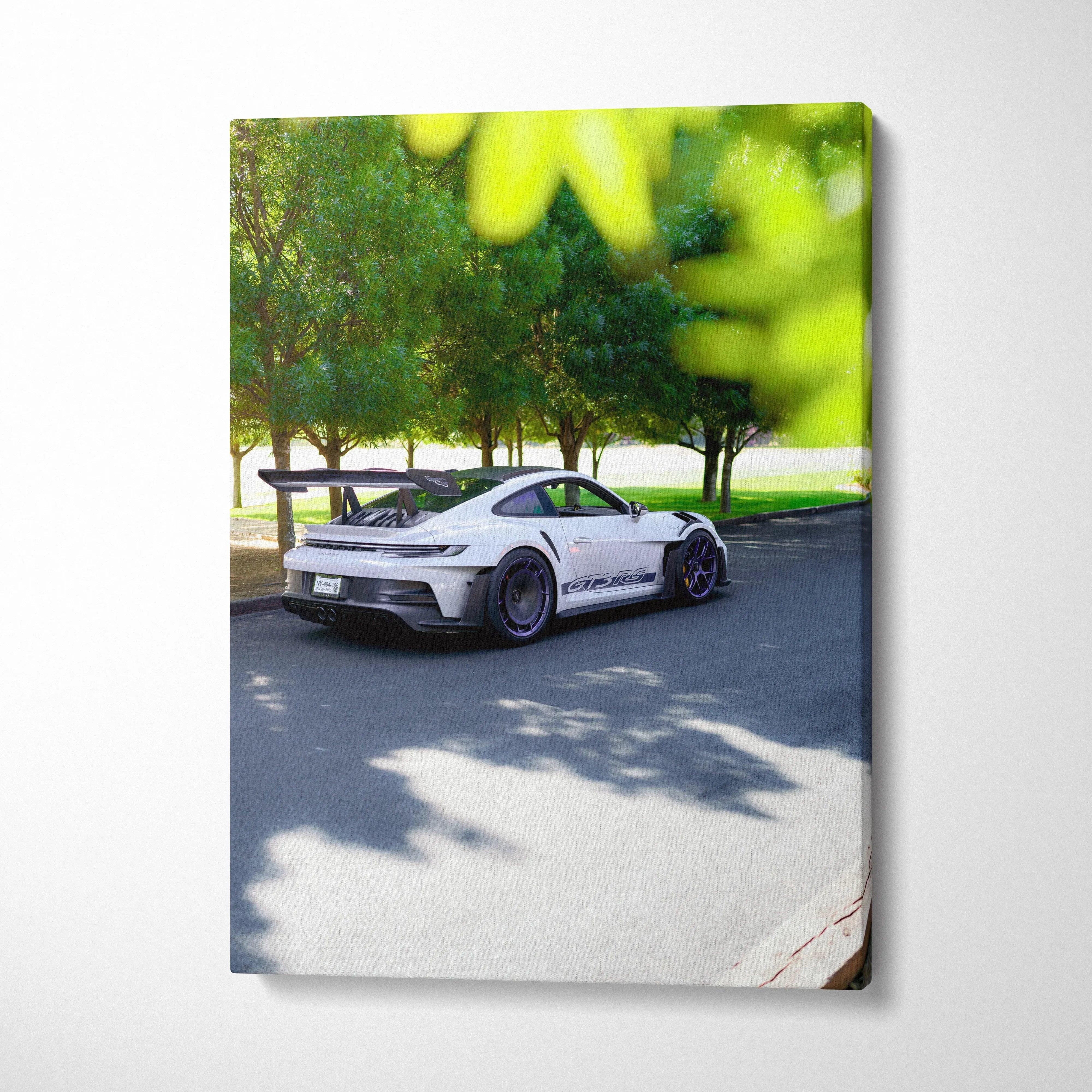Vertical canvas art of white Porsche 911 GT3 RS parked on street with trees and shadows.