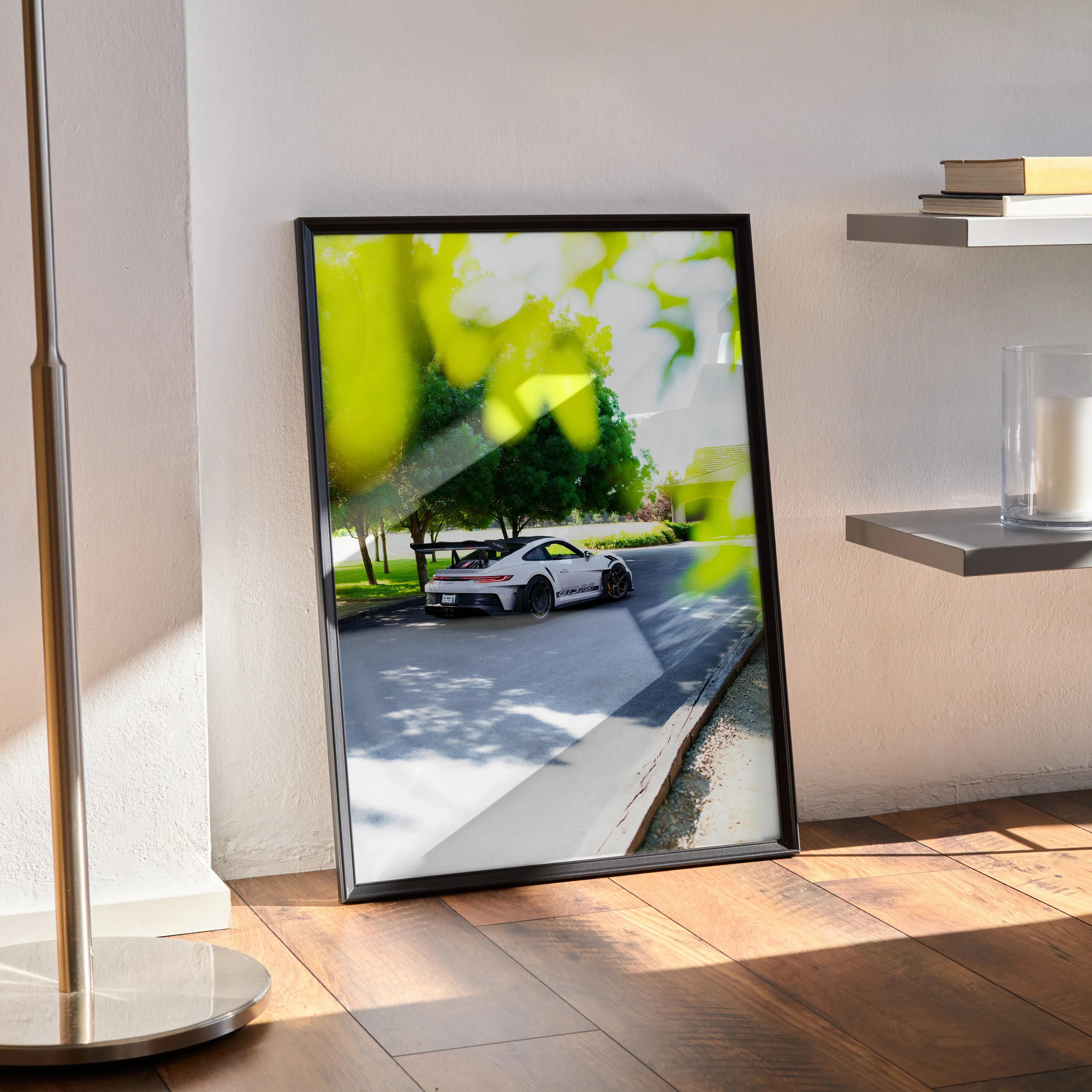 Porsche 911 GT3 RS poster showing white sports car on sunlit road, modern wall art in black frame.