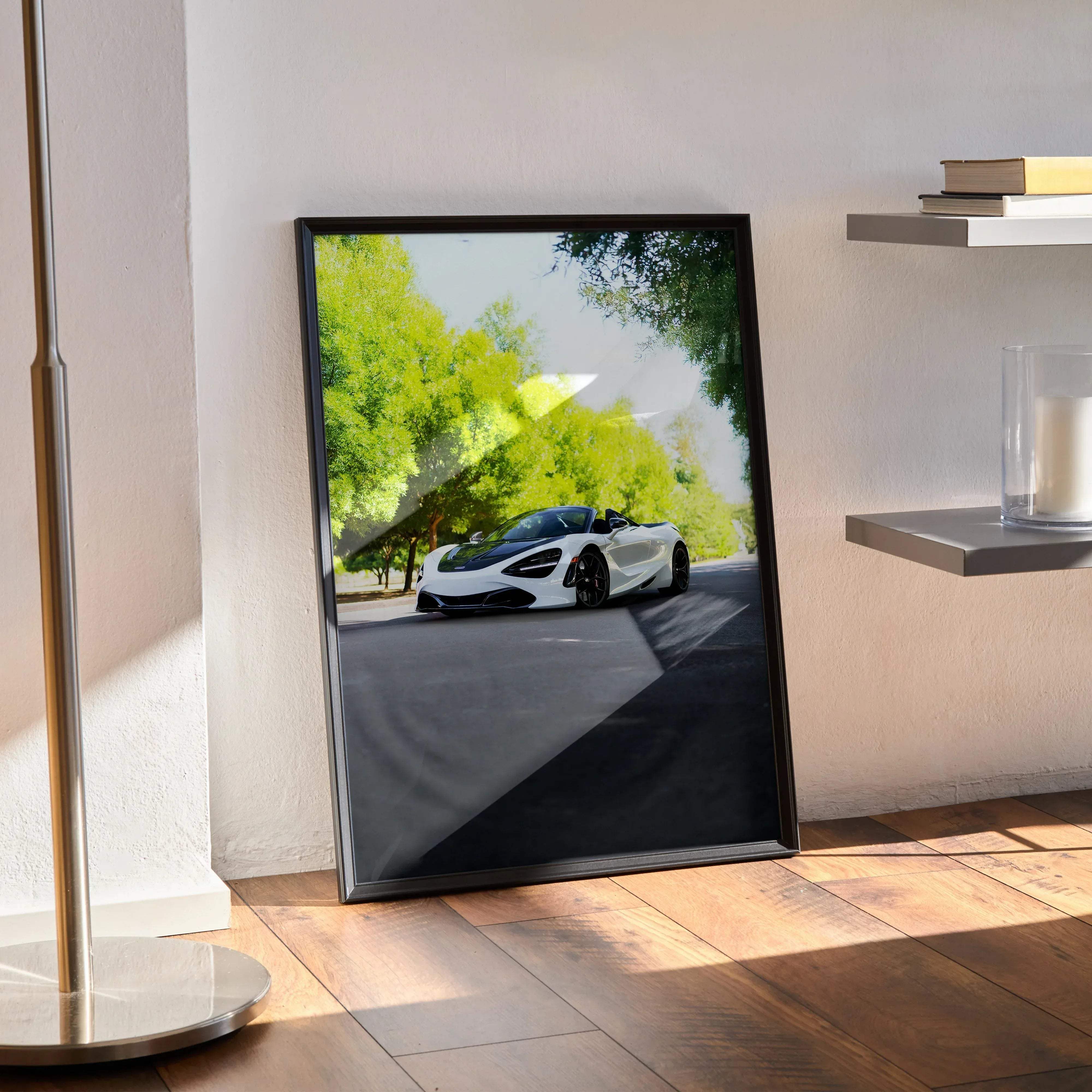 Black-framed poster of white mclaren 720s convertible speeding on sunlit tree-lined road high resolution car art