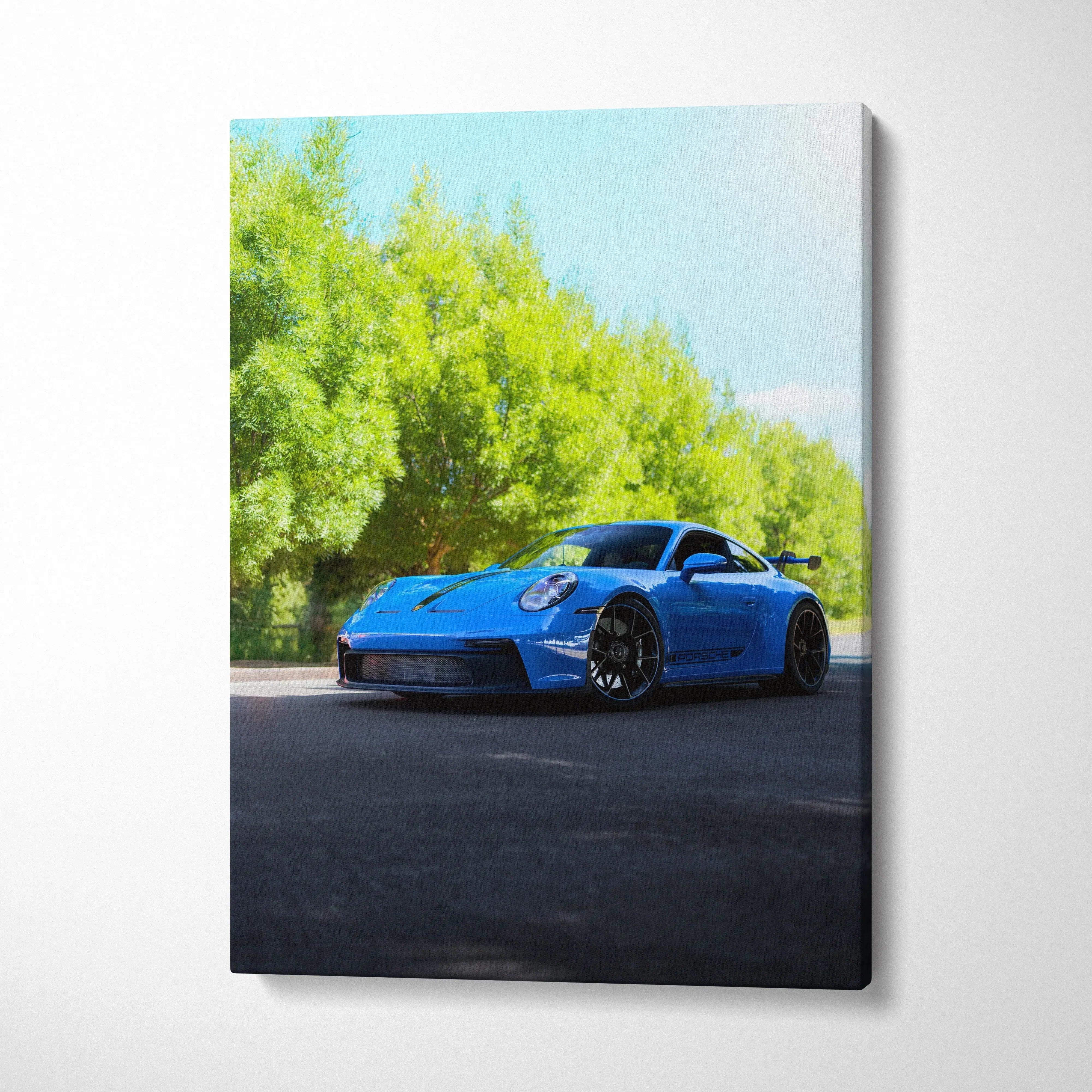 Blue Porsche 911 GT3 sports car on road with green trees canvas wall art.