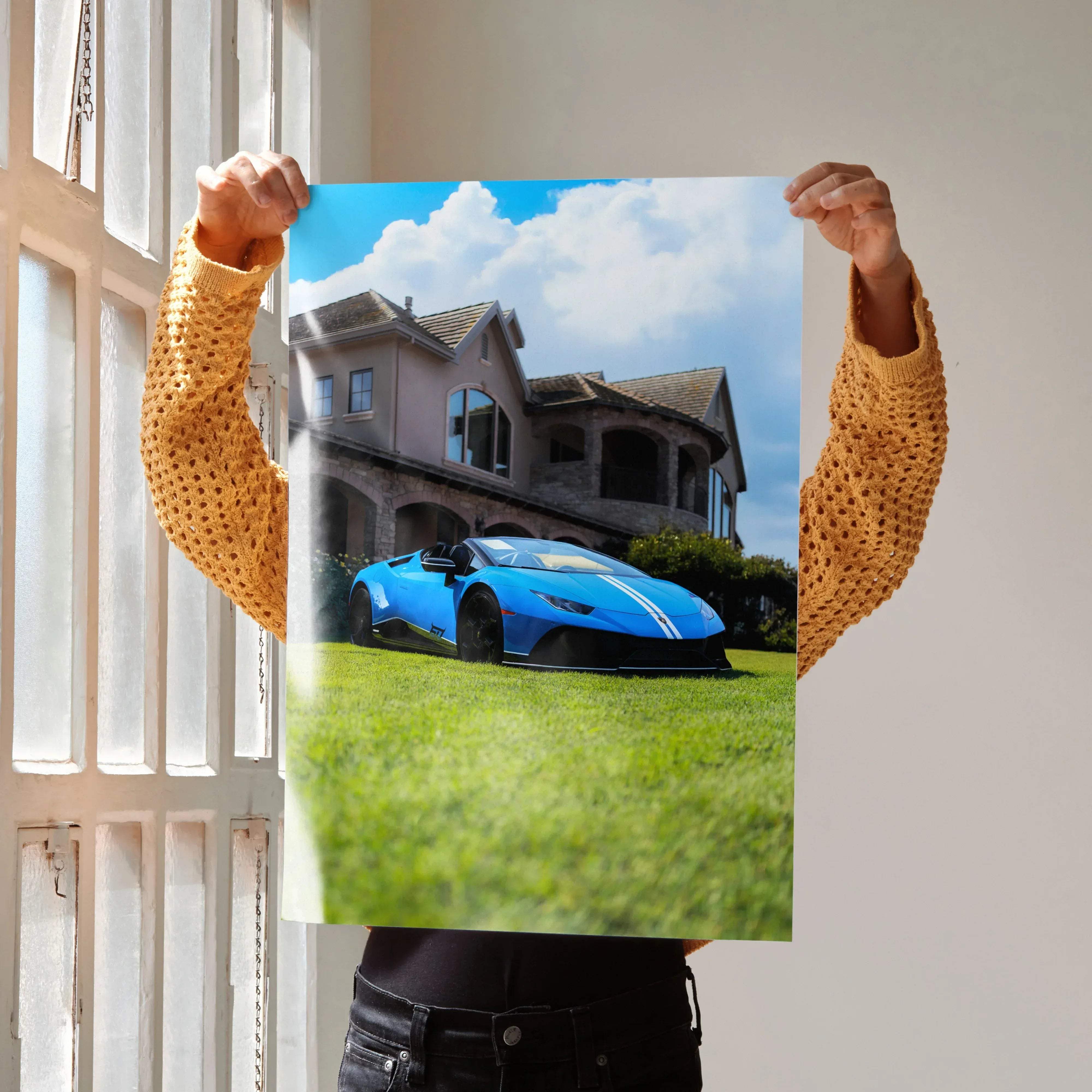 A vibrant blue lamborghini huracán with white racing stripes parked on a green lawn in front of an elegant mansion poster