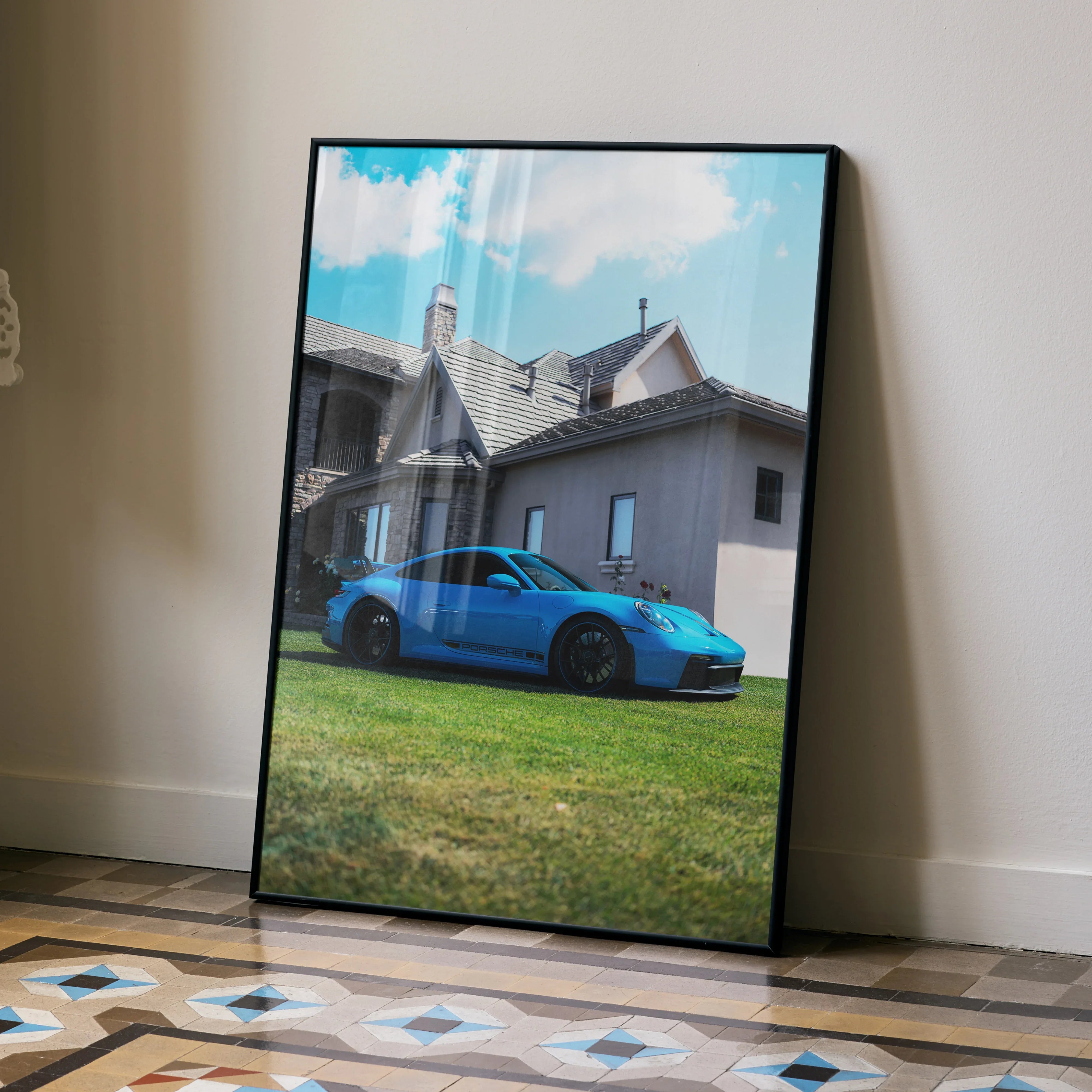 Blue Porsche 911 GT3 parked in front of house poster wall art in black frame.