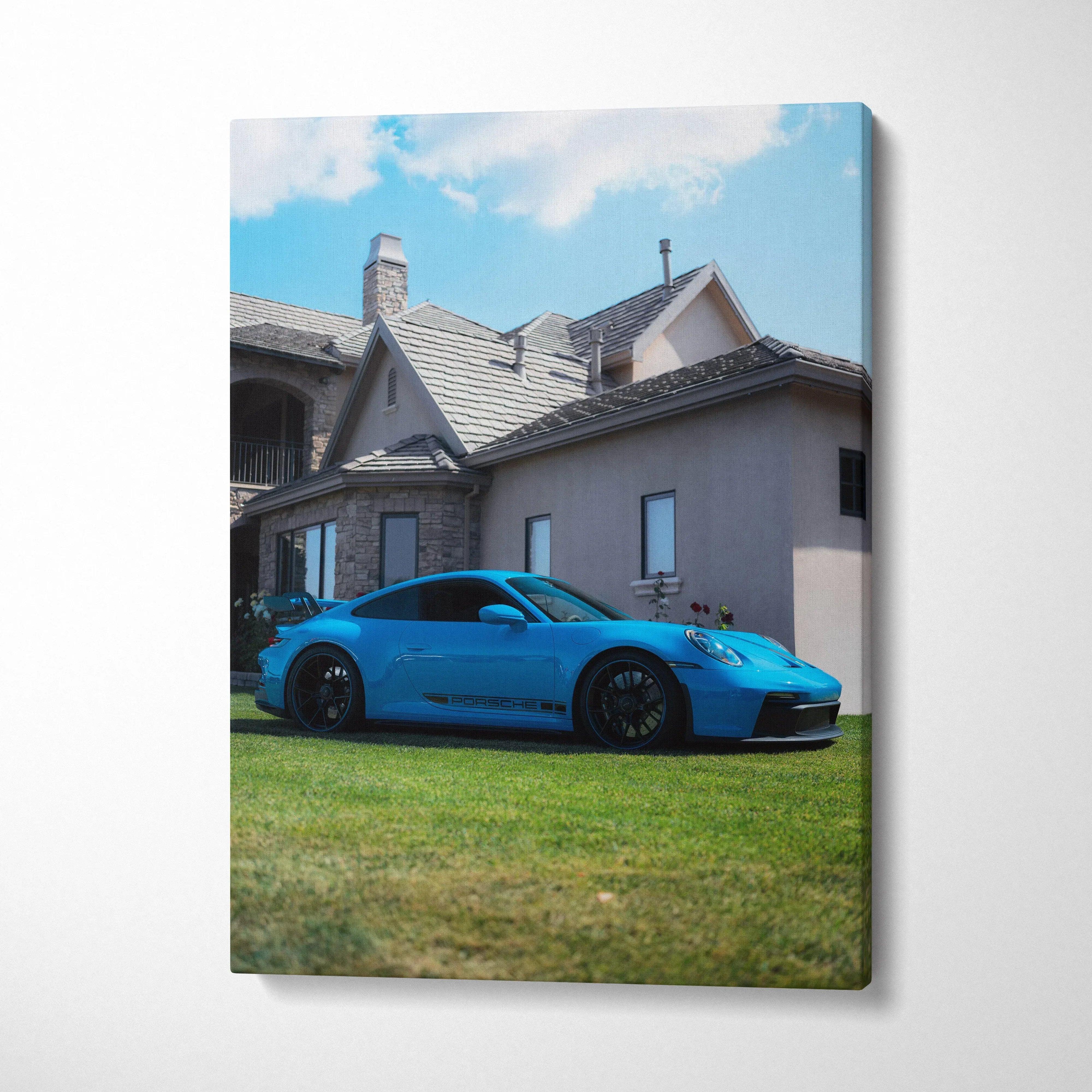 Porsche 911 GT3 in blue parked on grass in front of house canvas wall art vertical print.