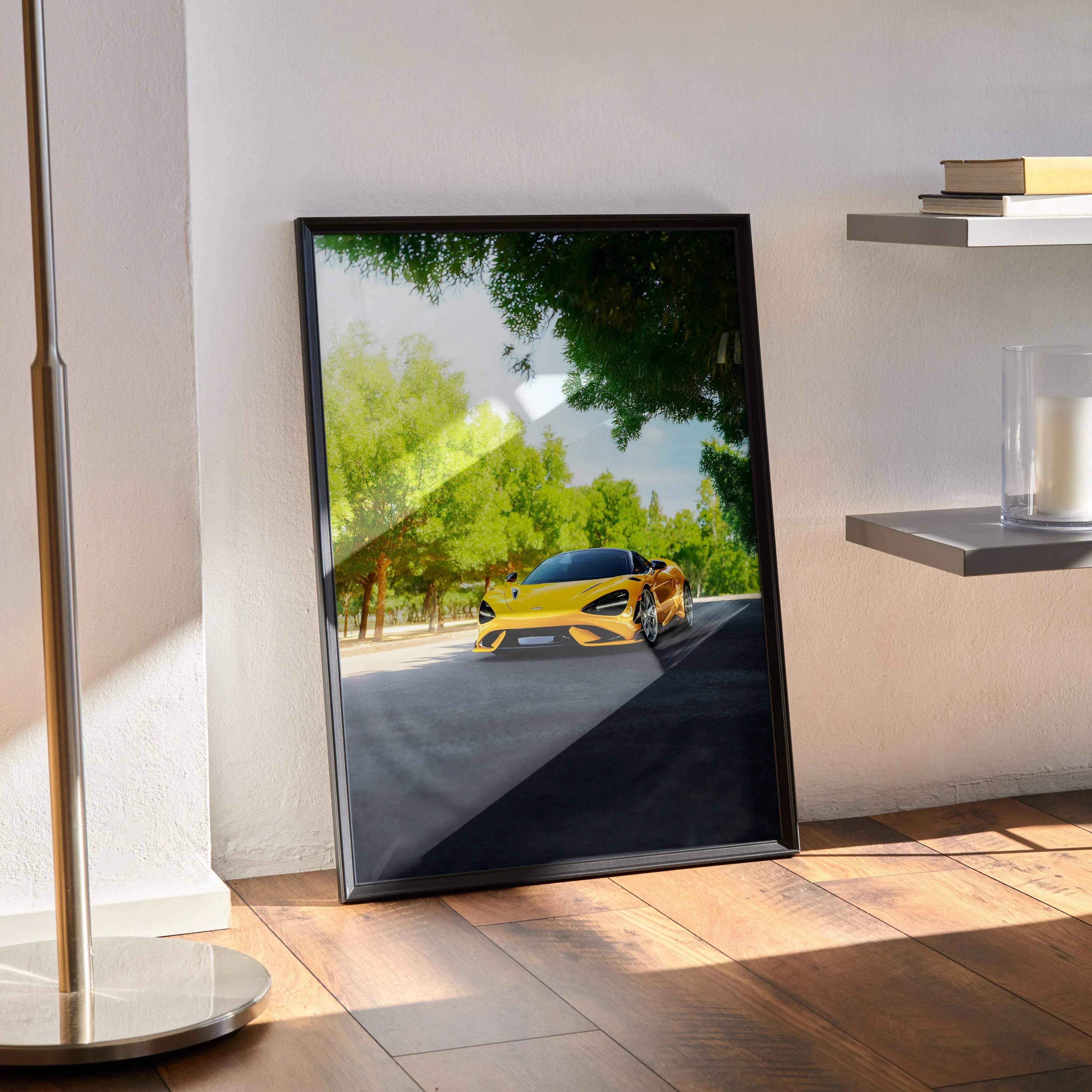 Black-framed poster of a vibrant yellow McLaren 765LT sports car speeding on a sunny tree-lined road high resolution