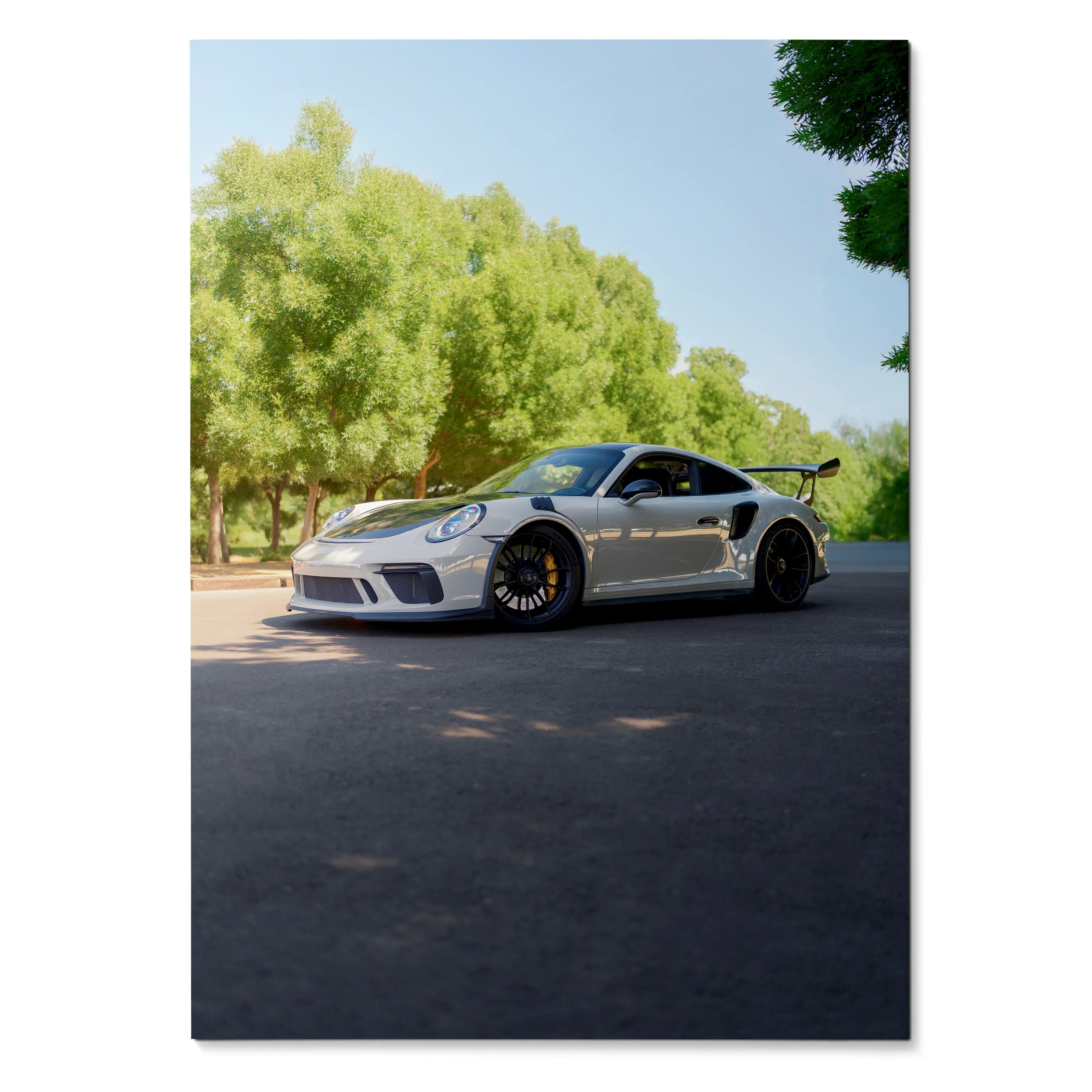Porsche 911 GT3 sports car parked on road with green trees poster wall art.
