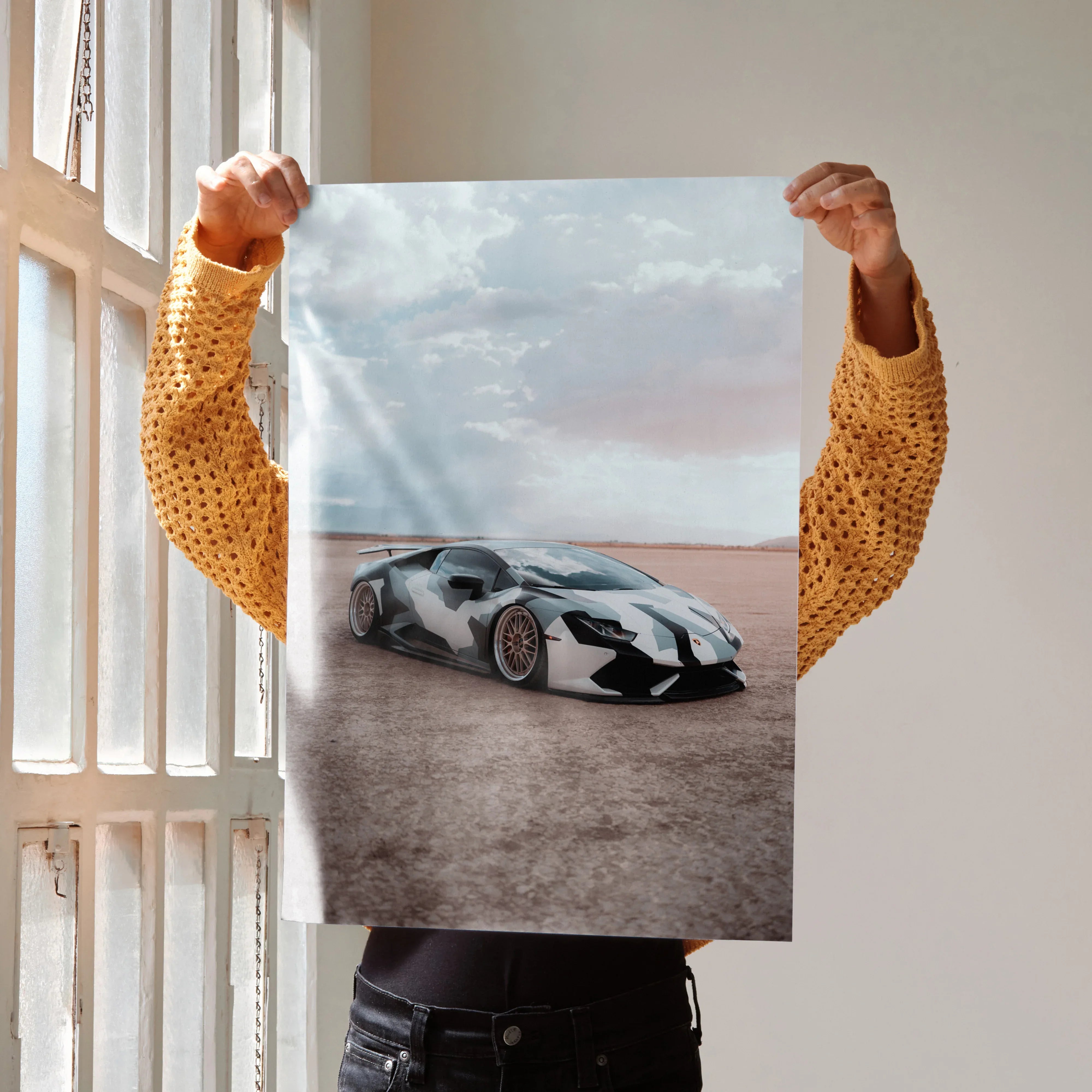 Lamborghini Huracan on desert road high-resolution poster wall art with cloudy sky backdrop.