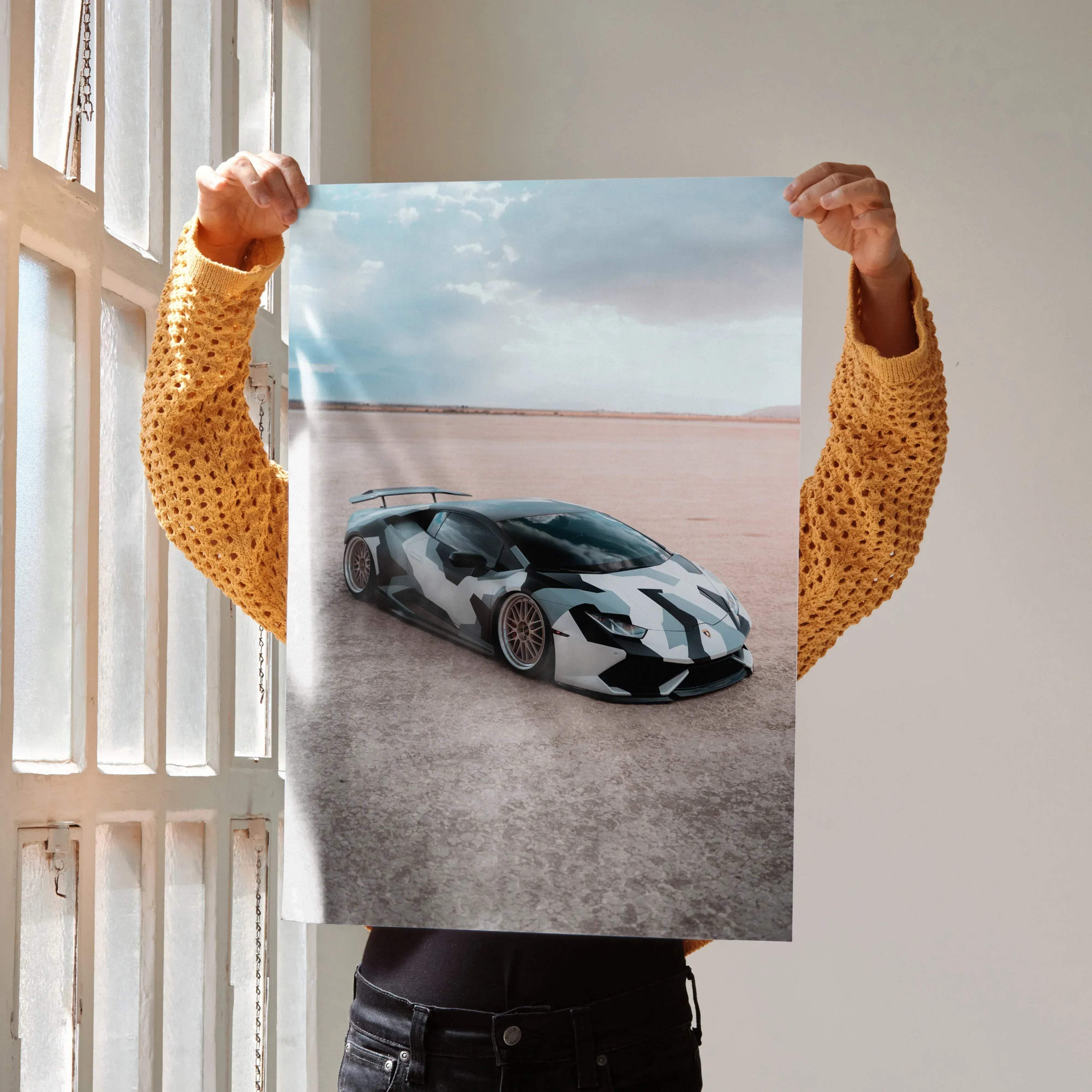 Lamborghini Huracan car poster featuring a sleek black and white geometric camouflage design with gold-rimmed wheels