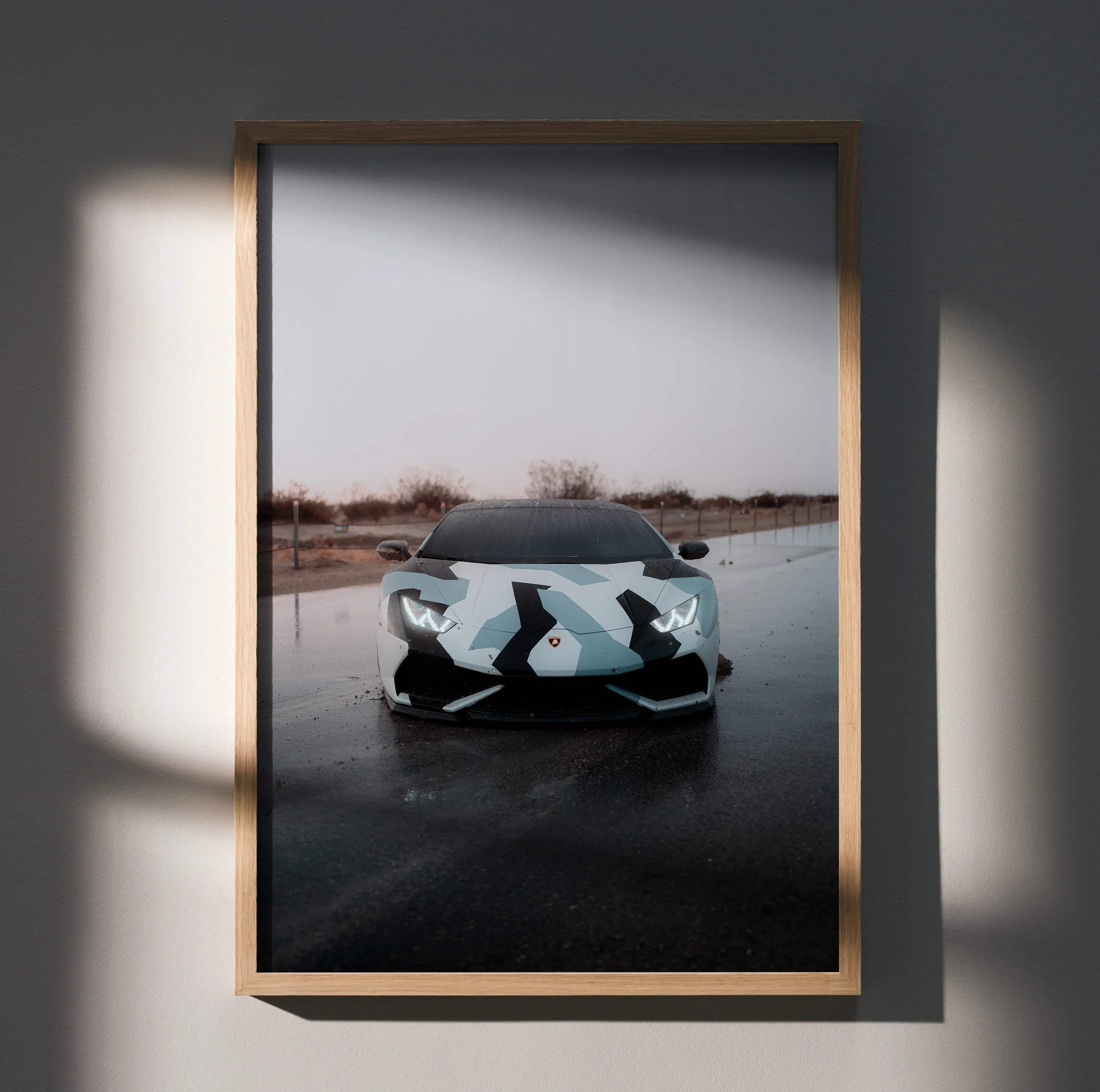 A framed high resolution car poster of a white and black camouflage patterned Lamborghini Huracan