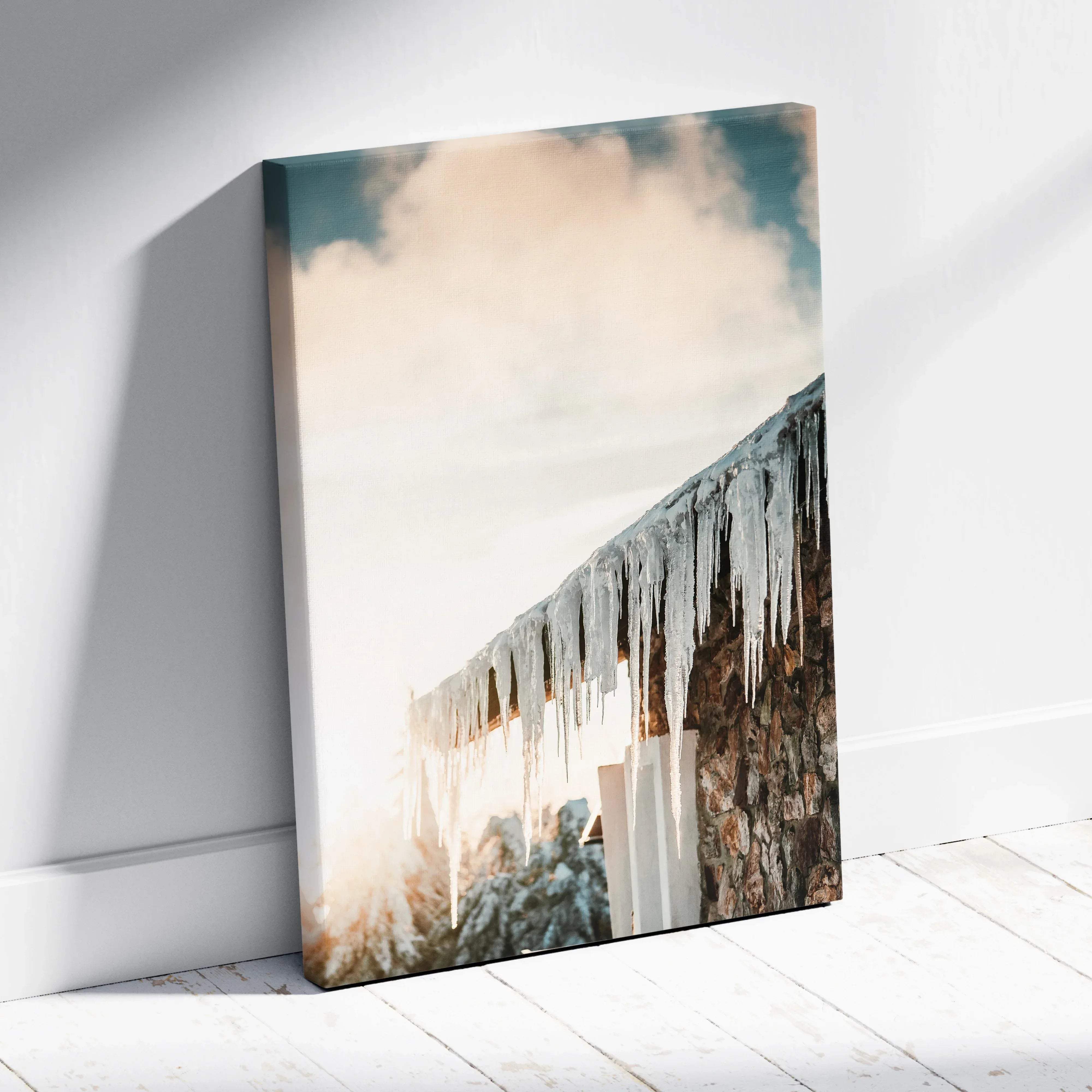 Rectangular canvas wall art featuring a rustic stone wall with glistening icicles under a soft cloudy sky in pastel tones