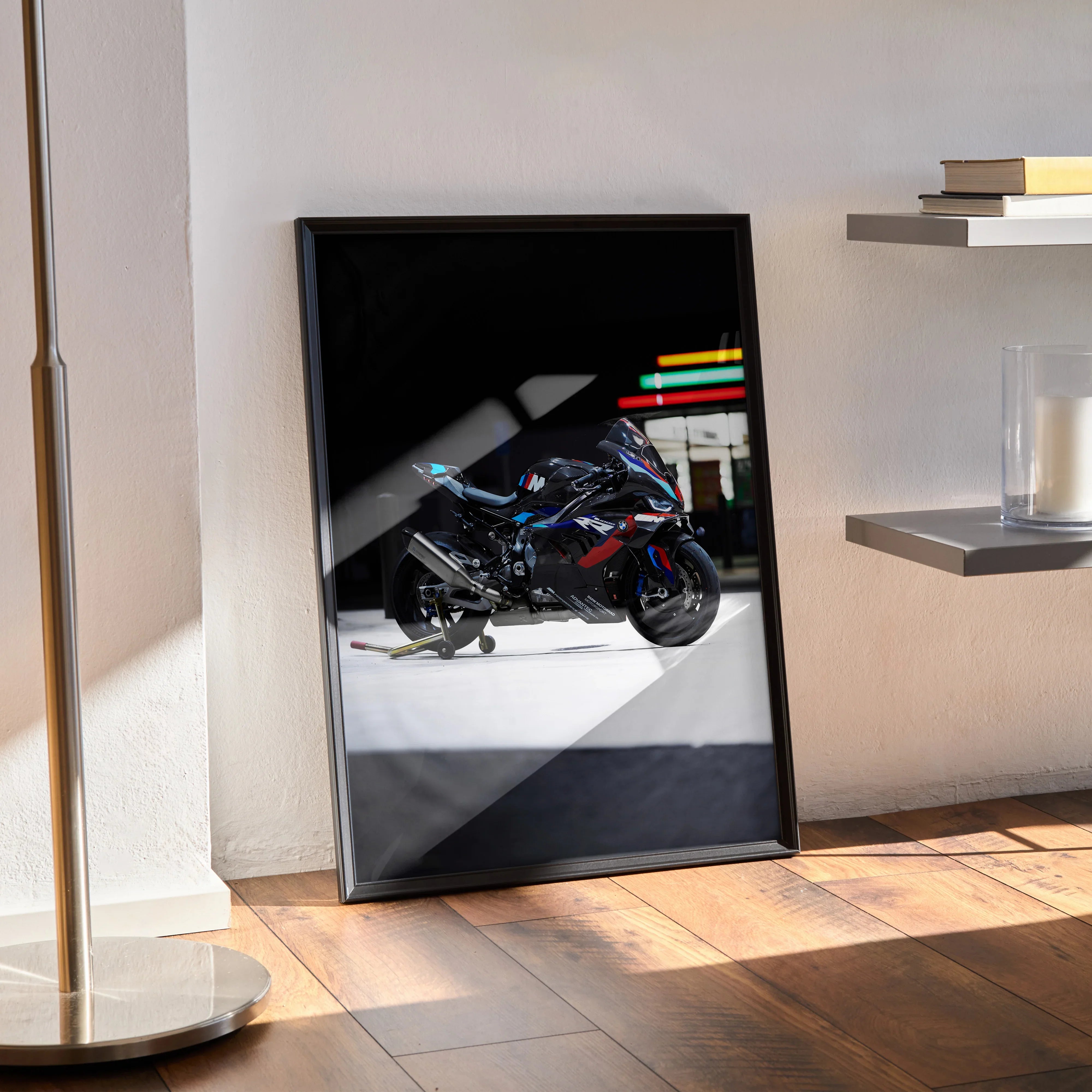 BMW M1000RR motorcycle poster wall art with sleek black frame and colorful accents in modern room setting.