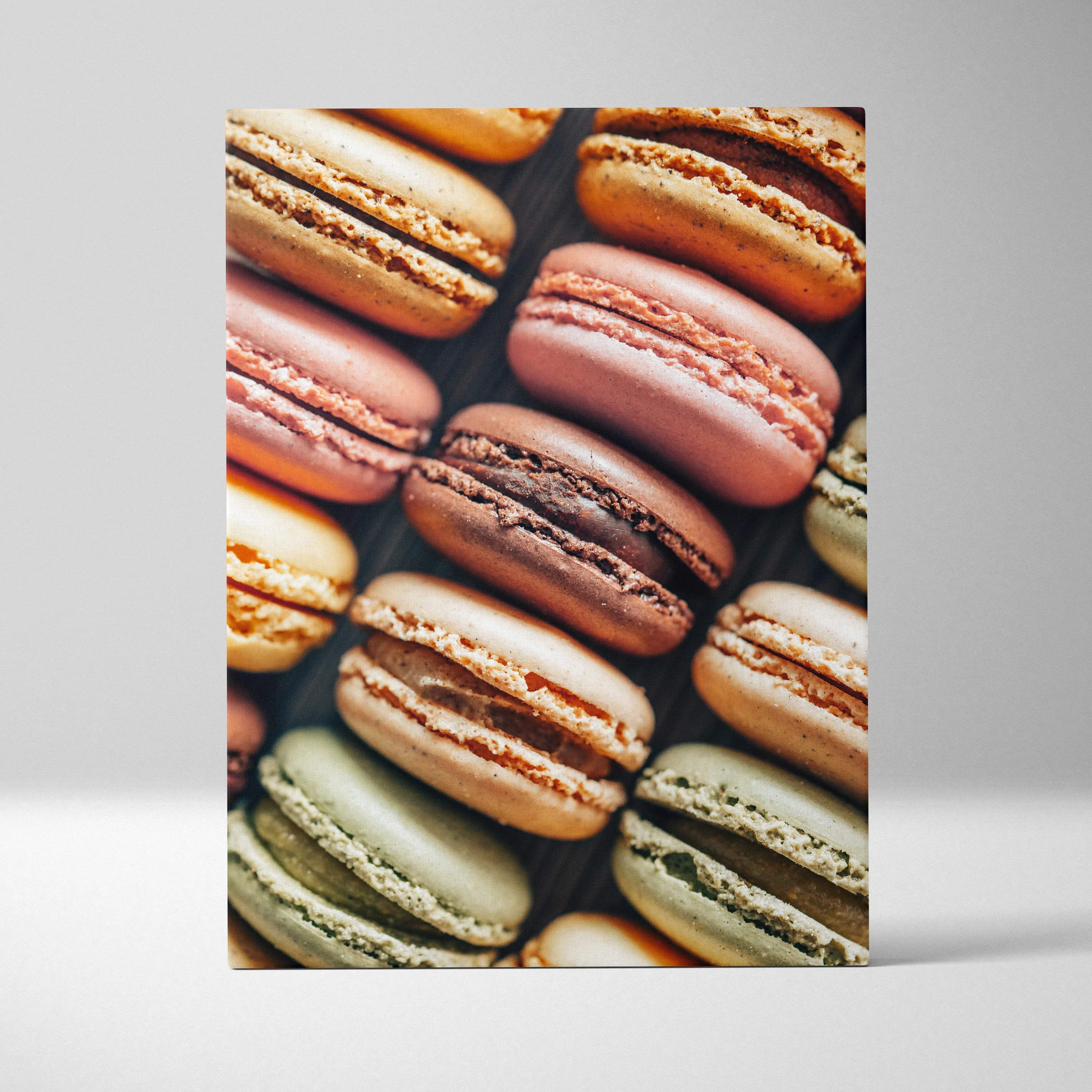 A rectangular canvas print featuring vibrant colorful macarons in pink beige brown and green for wall art decor