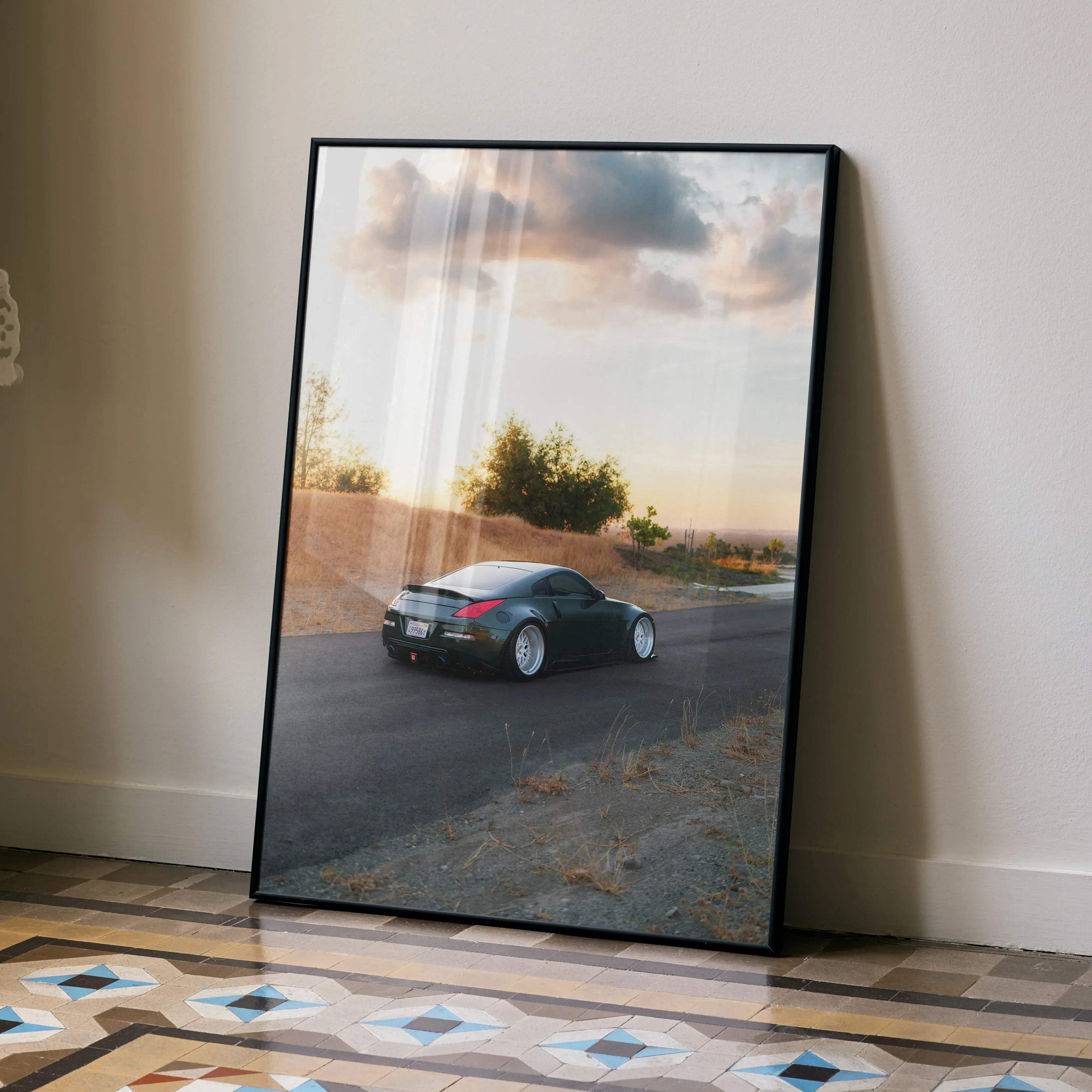 Black-framed art print featuring a dark green nissan 350z sports car in motion on a sunlit road high resolution poster