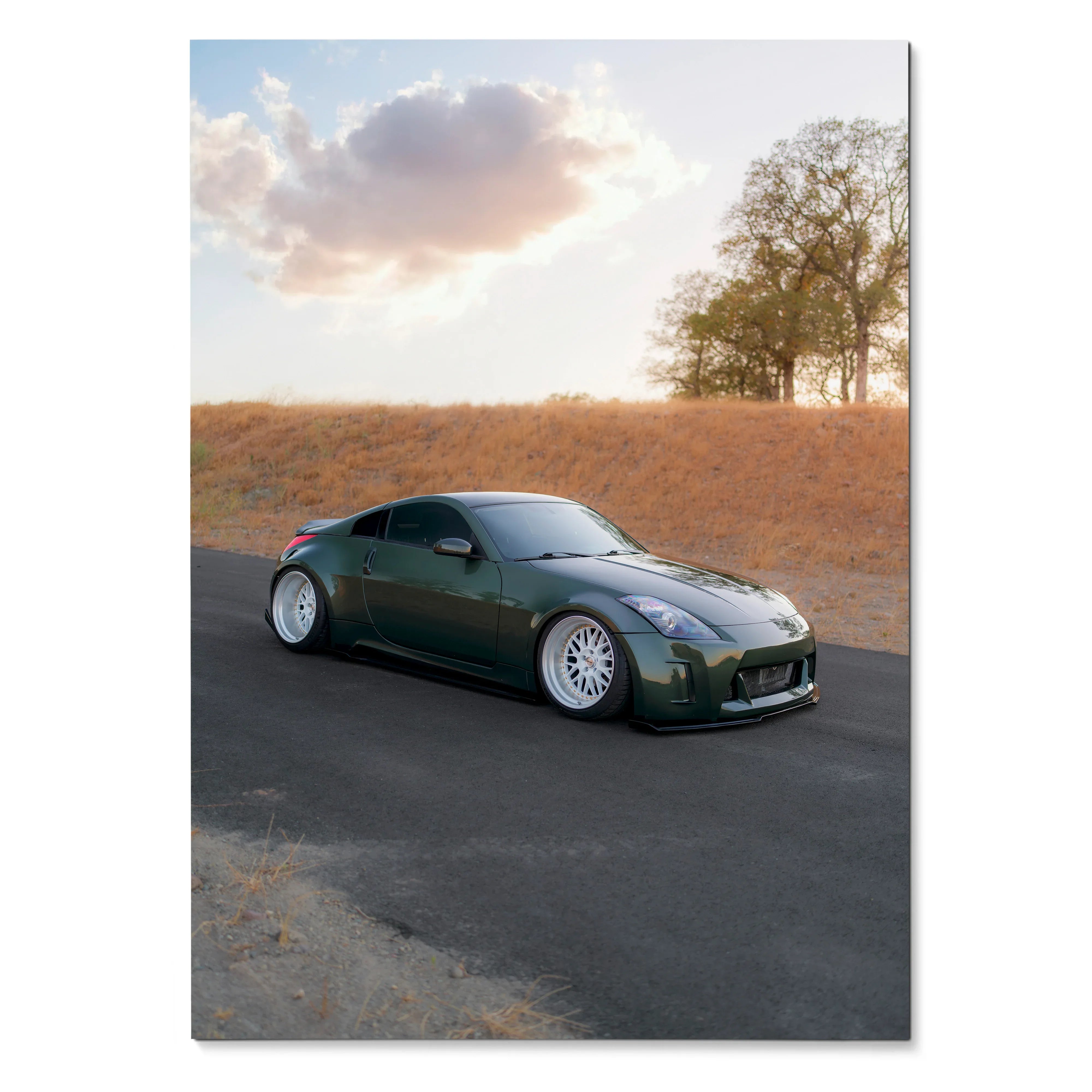 Nissan 350z in dark green on road at sunset poster wall art with autumn trees background.
