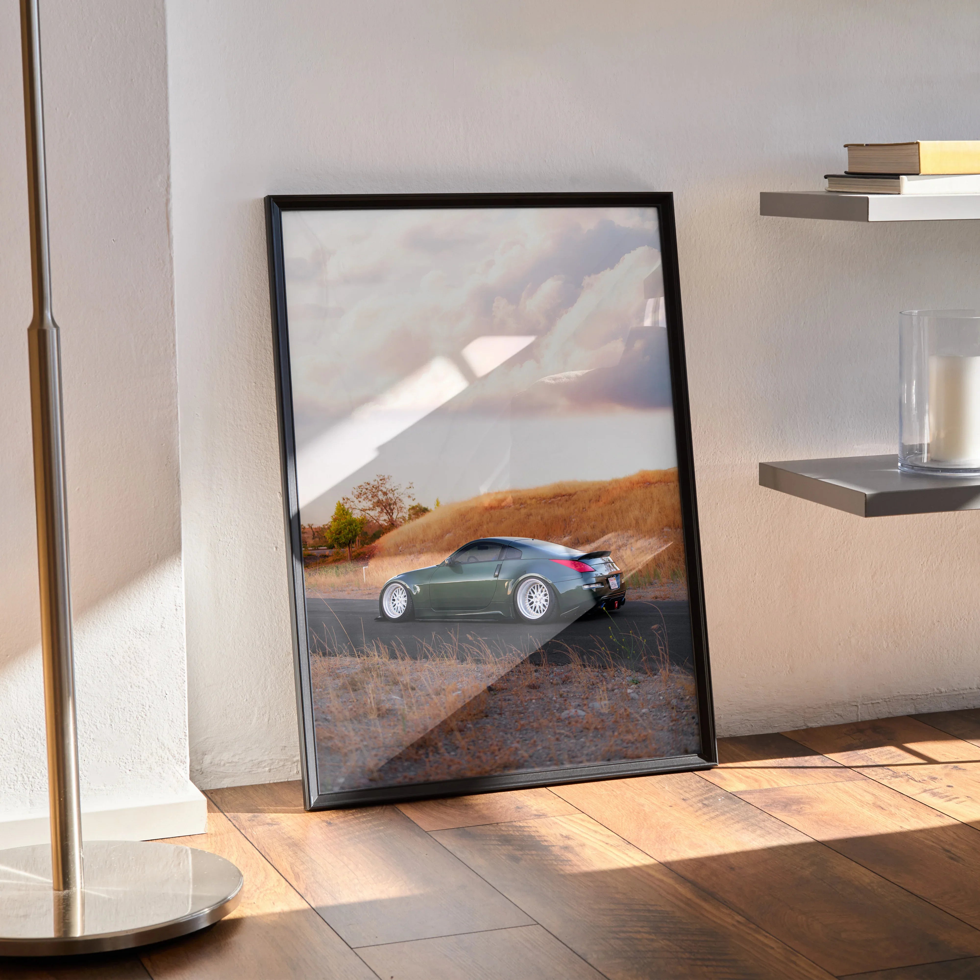 Nissan 350z poster wall art featuring sleek gray car against scenic sunset background.