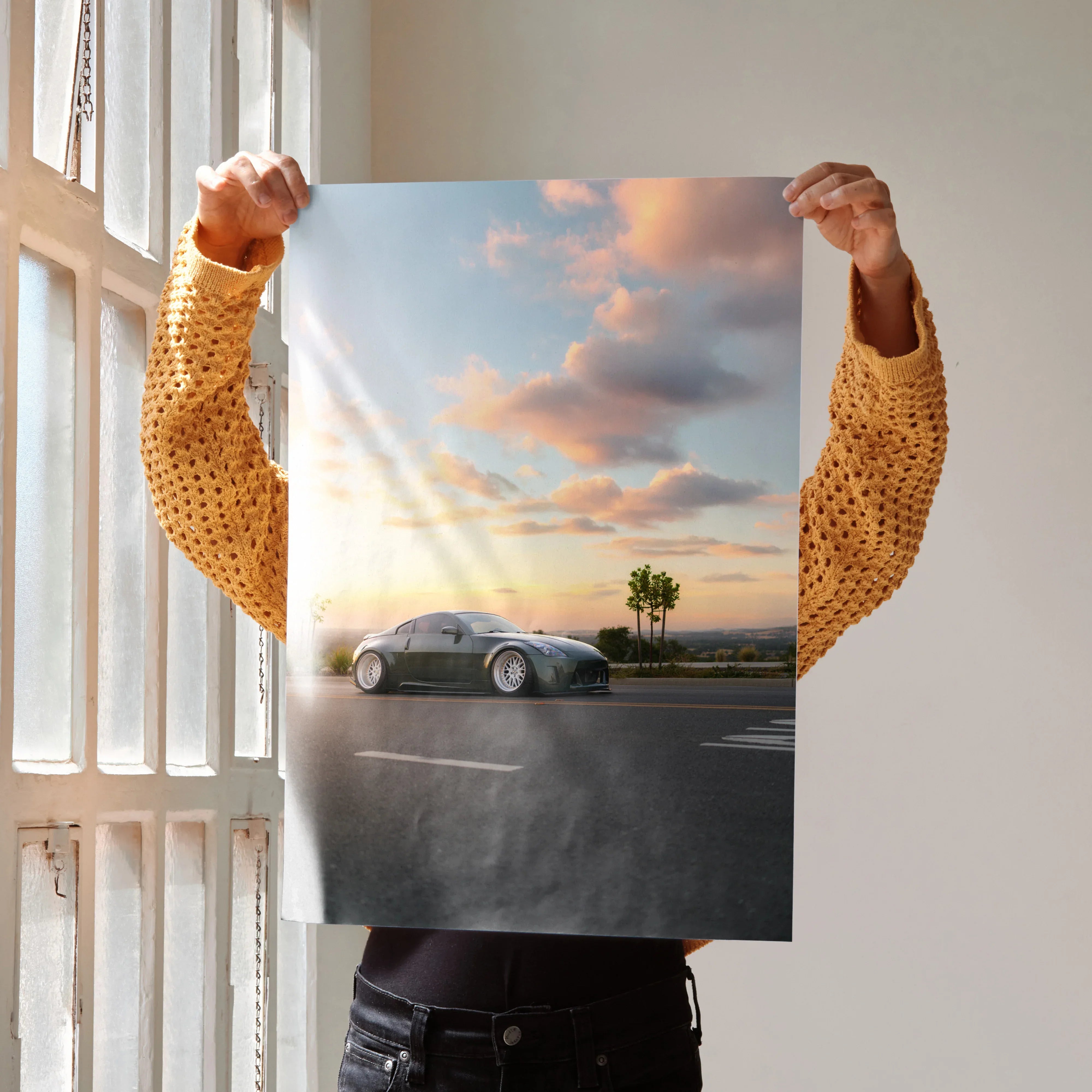 Nissan 350z poster wall art with car on road at sunset and palm tree background.