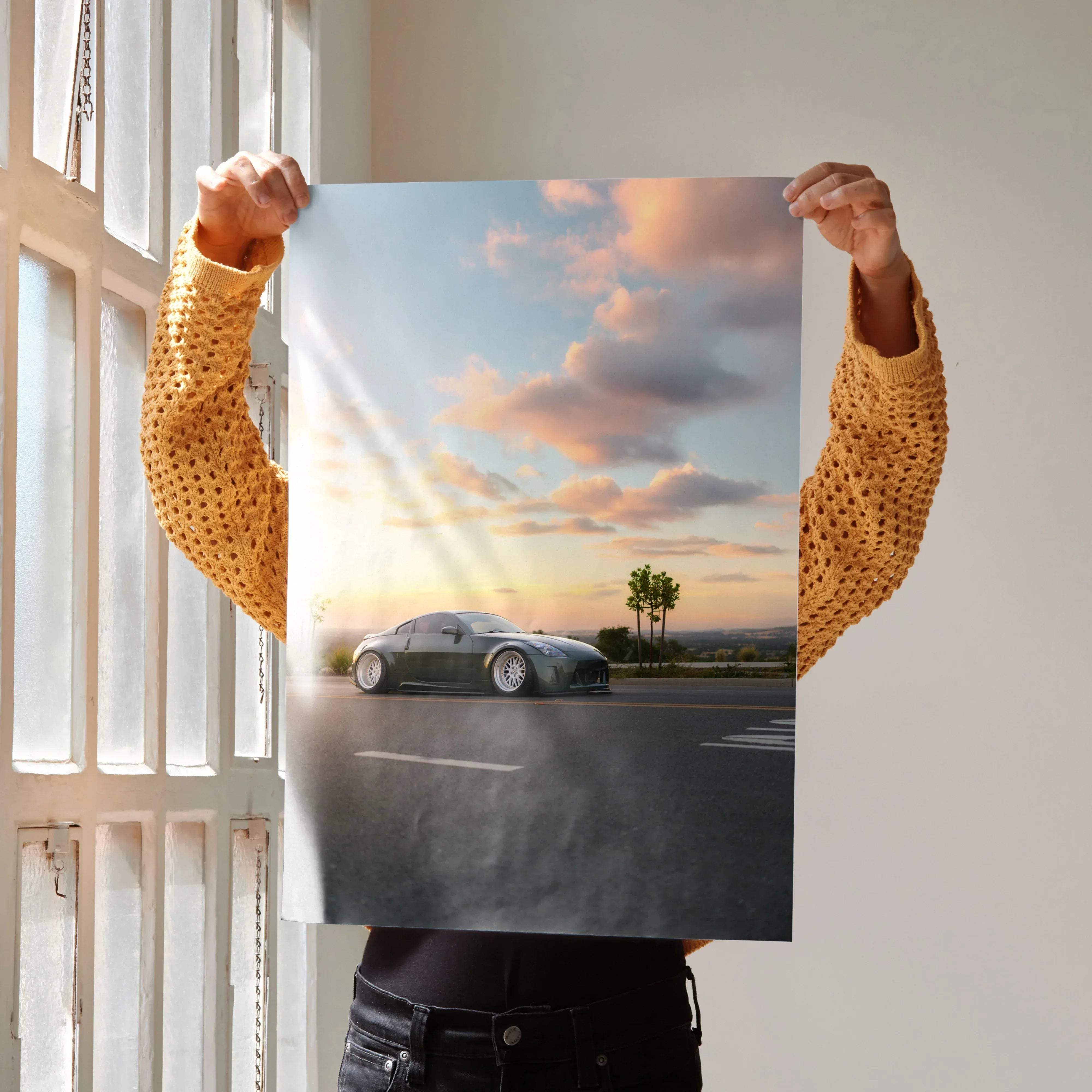 A sleek matte black nissan 350z sports car with silver rims shown in a dynamic pose on a high resolution poster