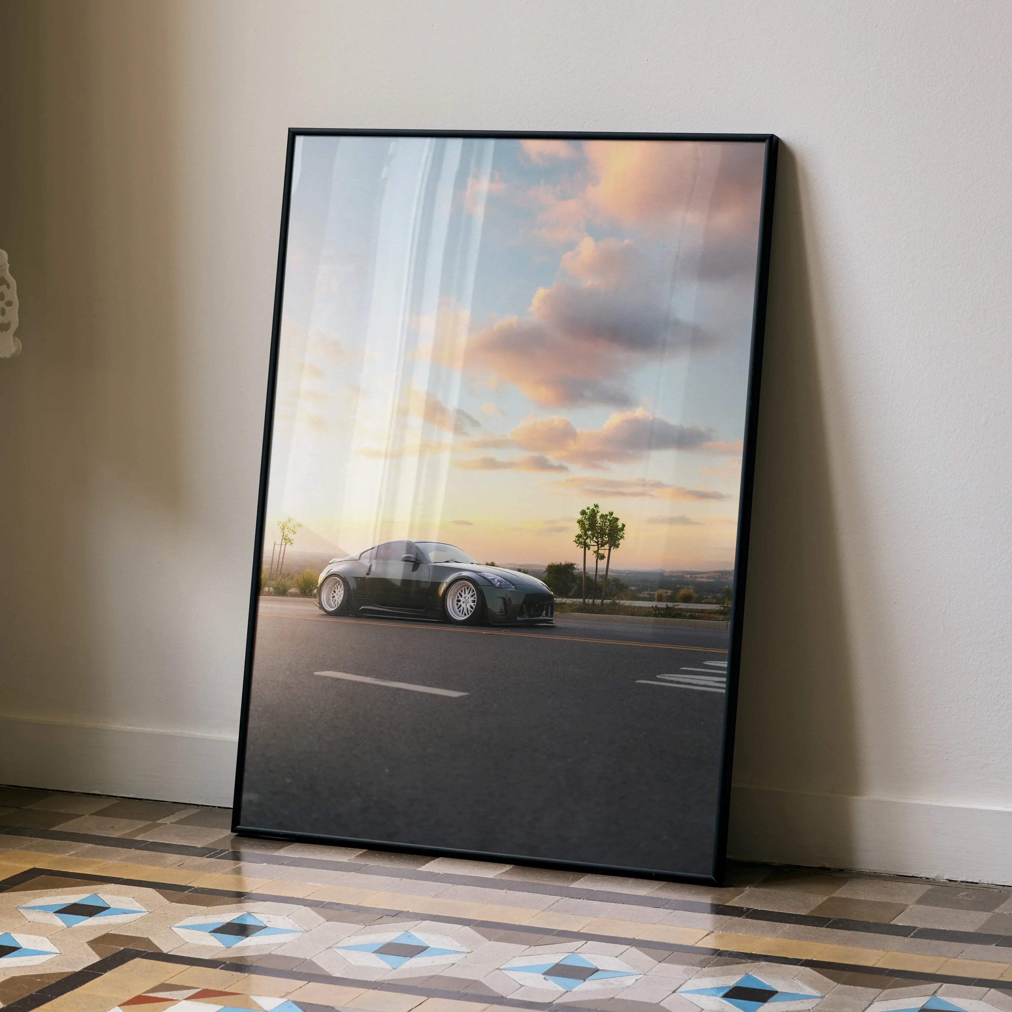 Black-framed art print featuring a sleek black nissan 350z sports car under a pastel-hued sky poster