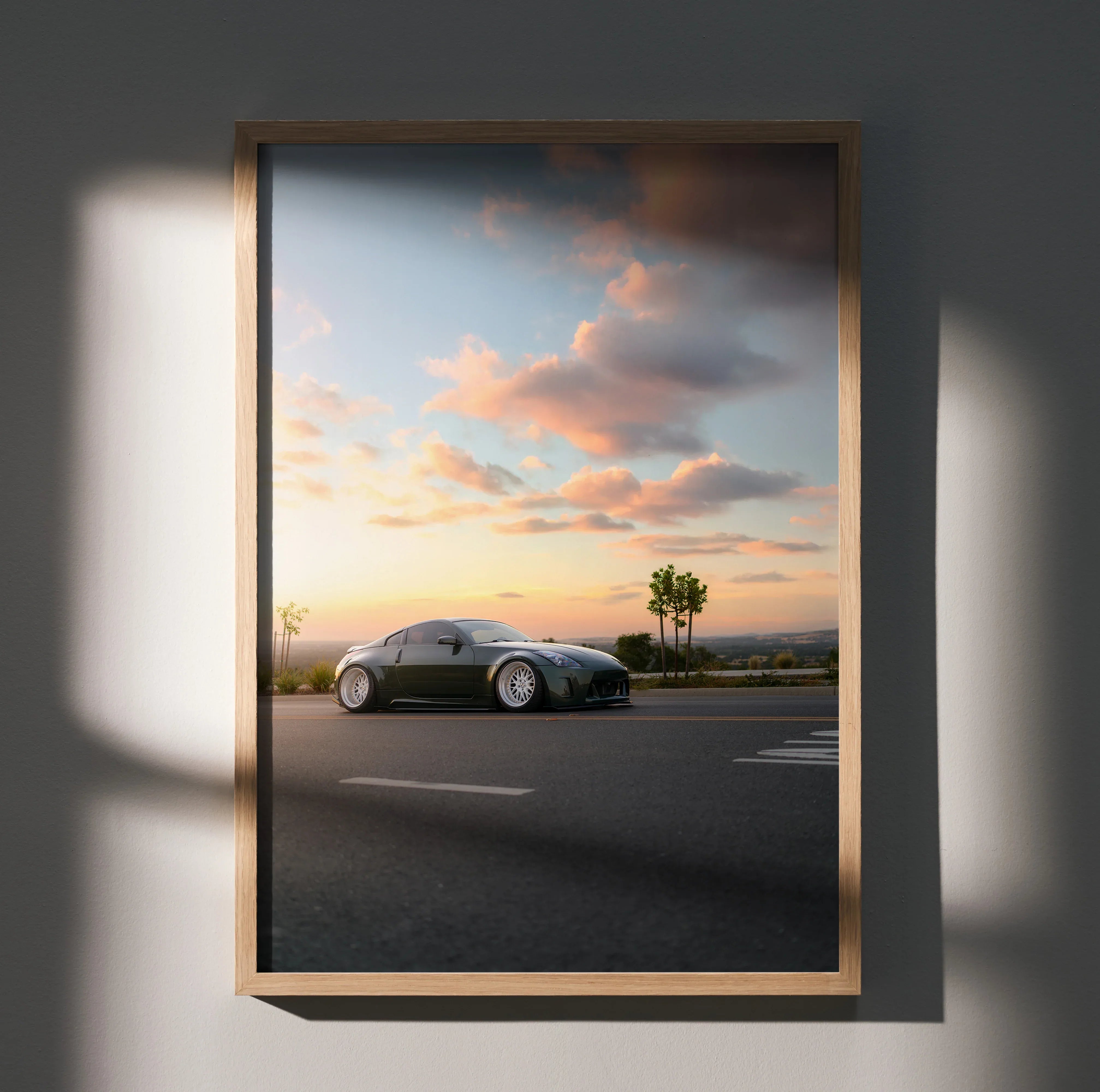 Nissan 350z car on highway at sunset poster wall art with vibrant sky and palm trees.